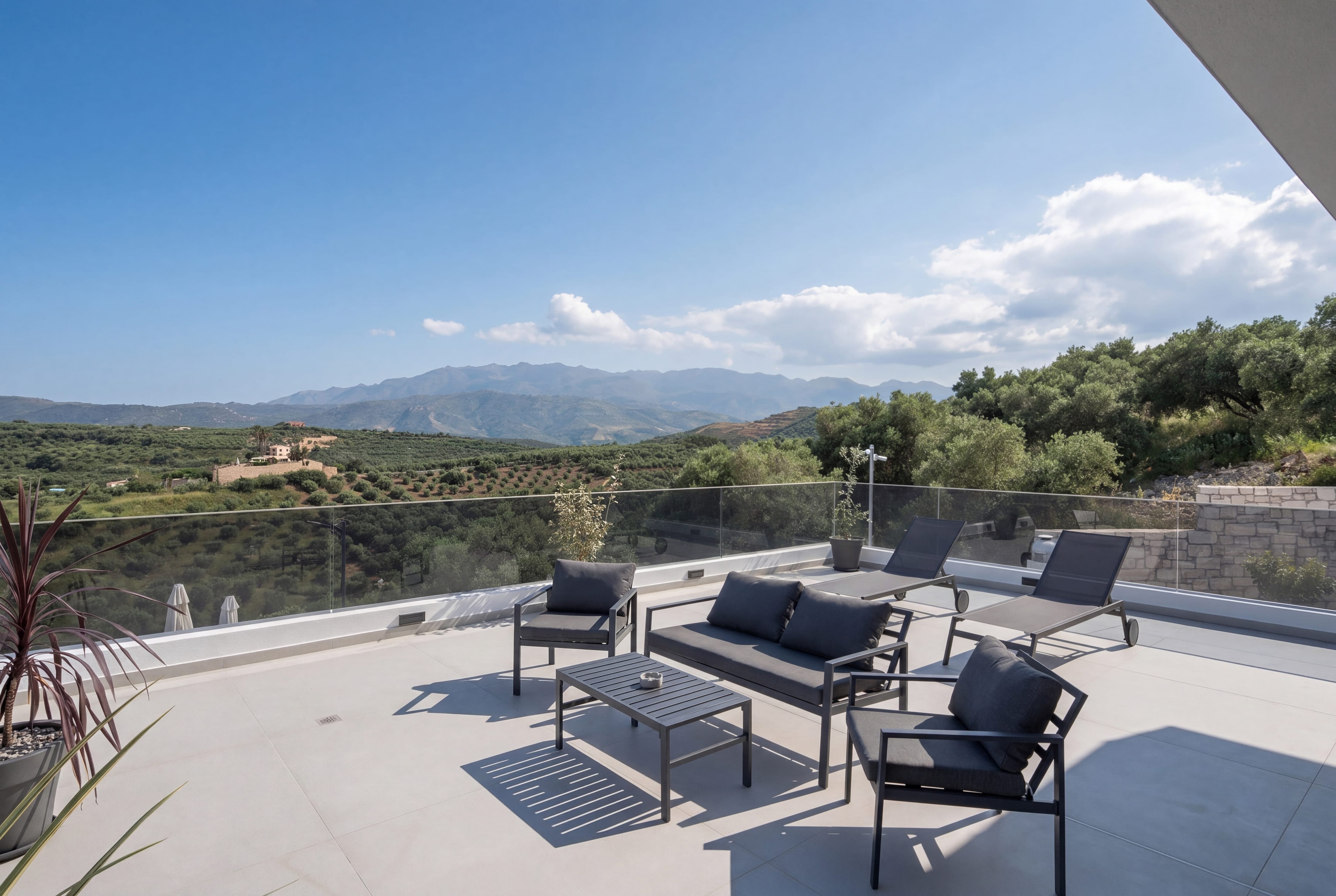 a patio with chairs and a table
