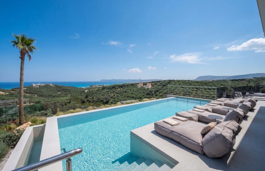 a pool with a deck and couches