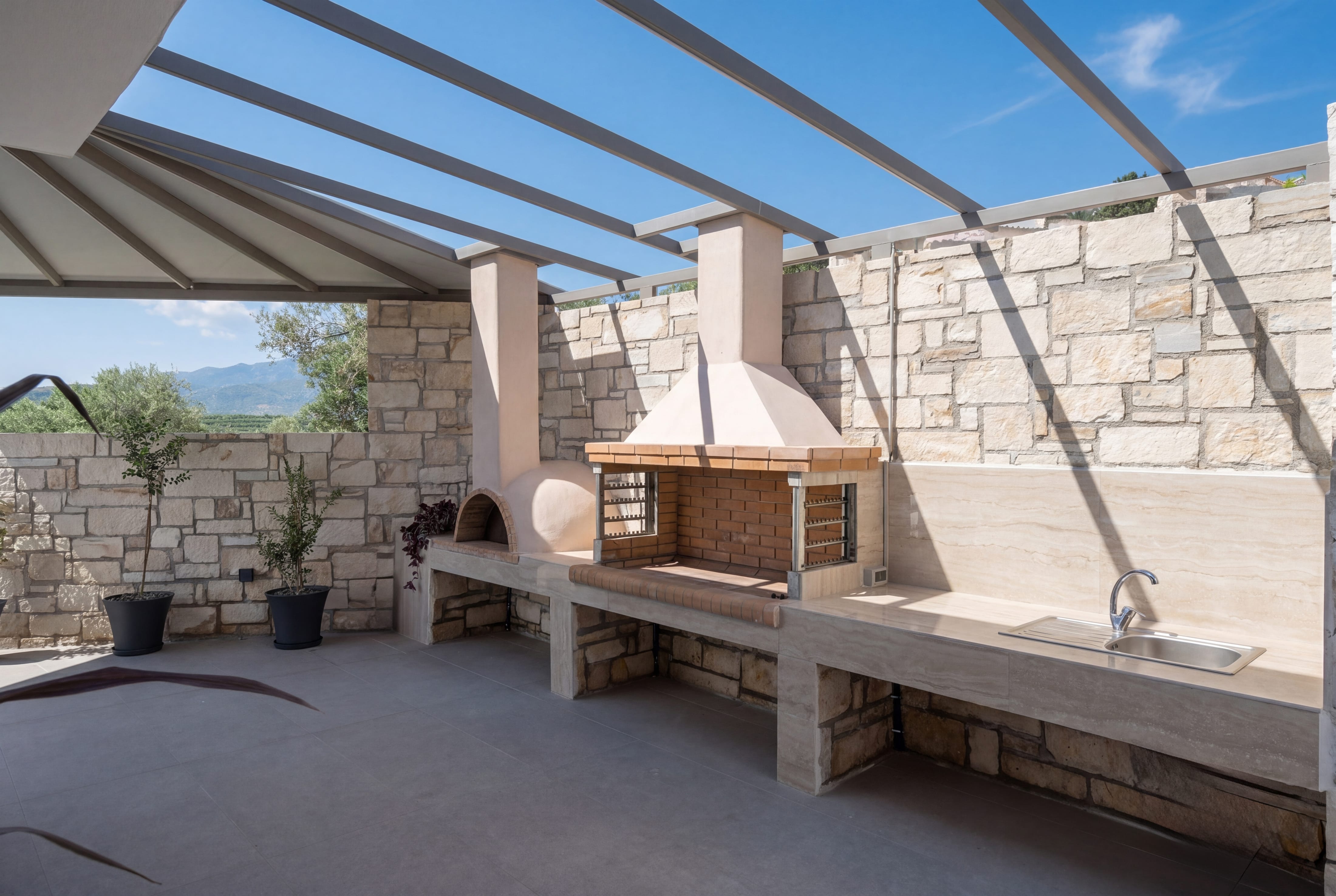 a stone patio with a fireplace
