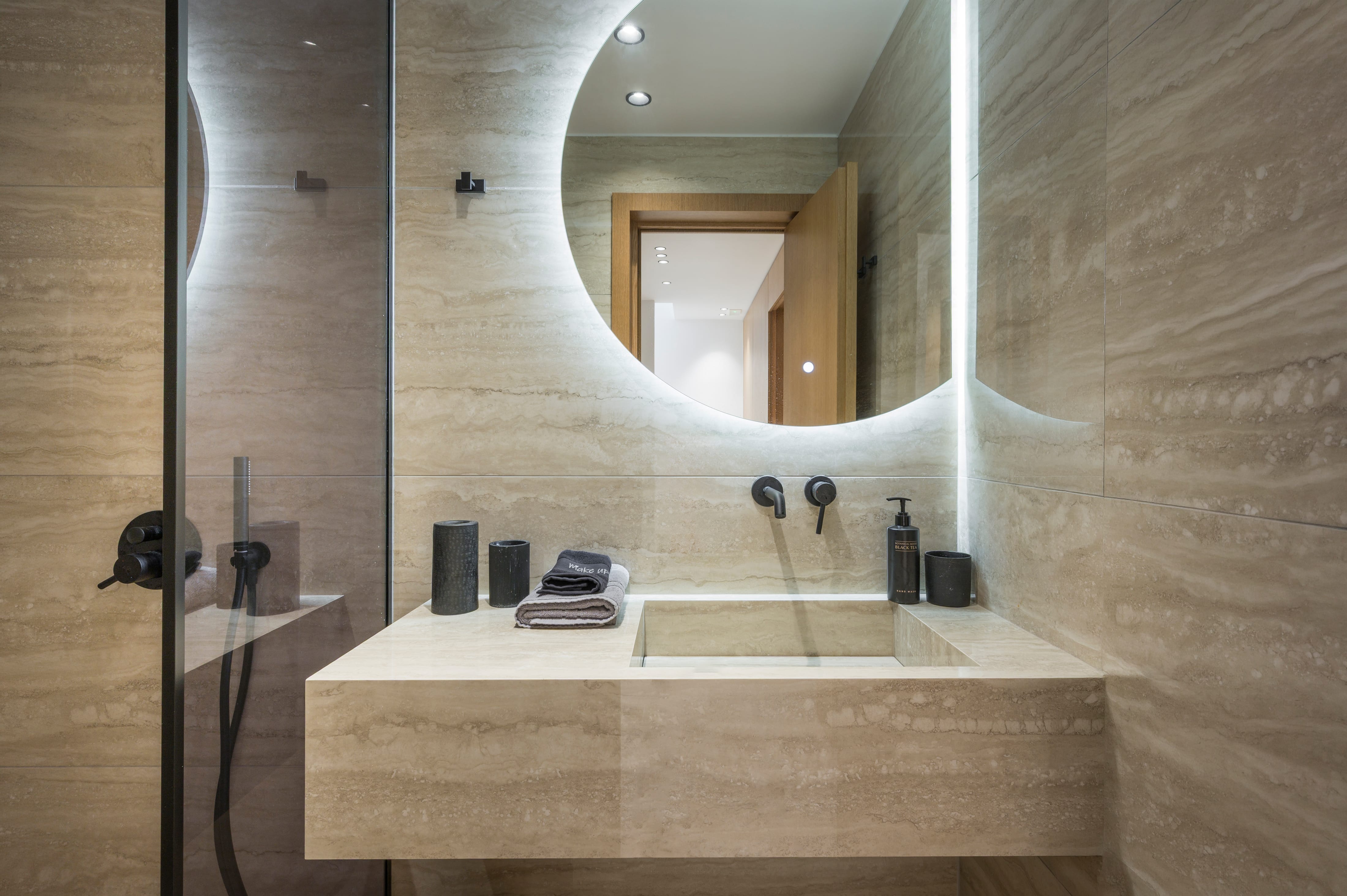 a bathroom with a round mirror