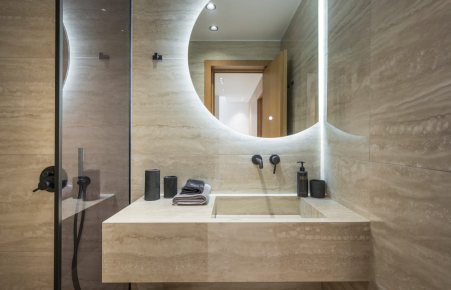 a bathroom with a round mirror