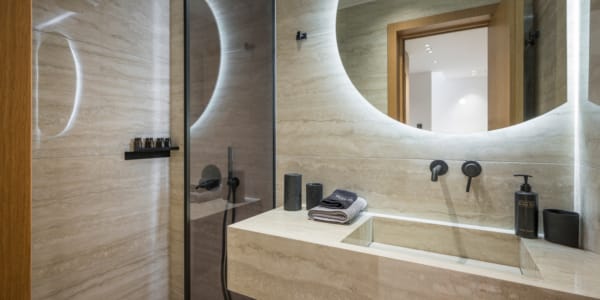 a bathroom with a round mirror