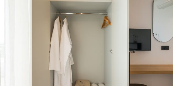 a closet with white towels and a swinger