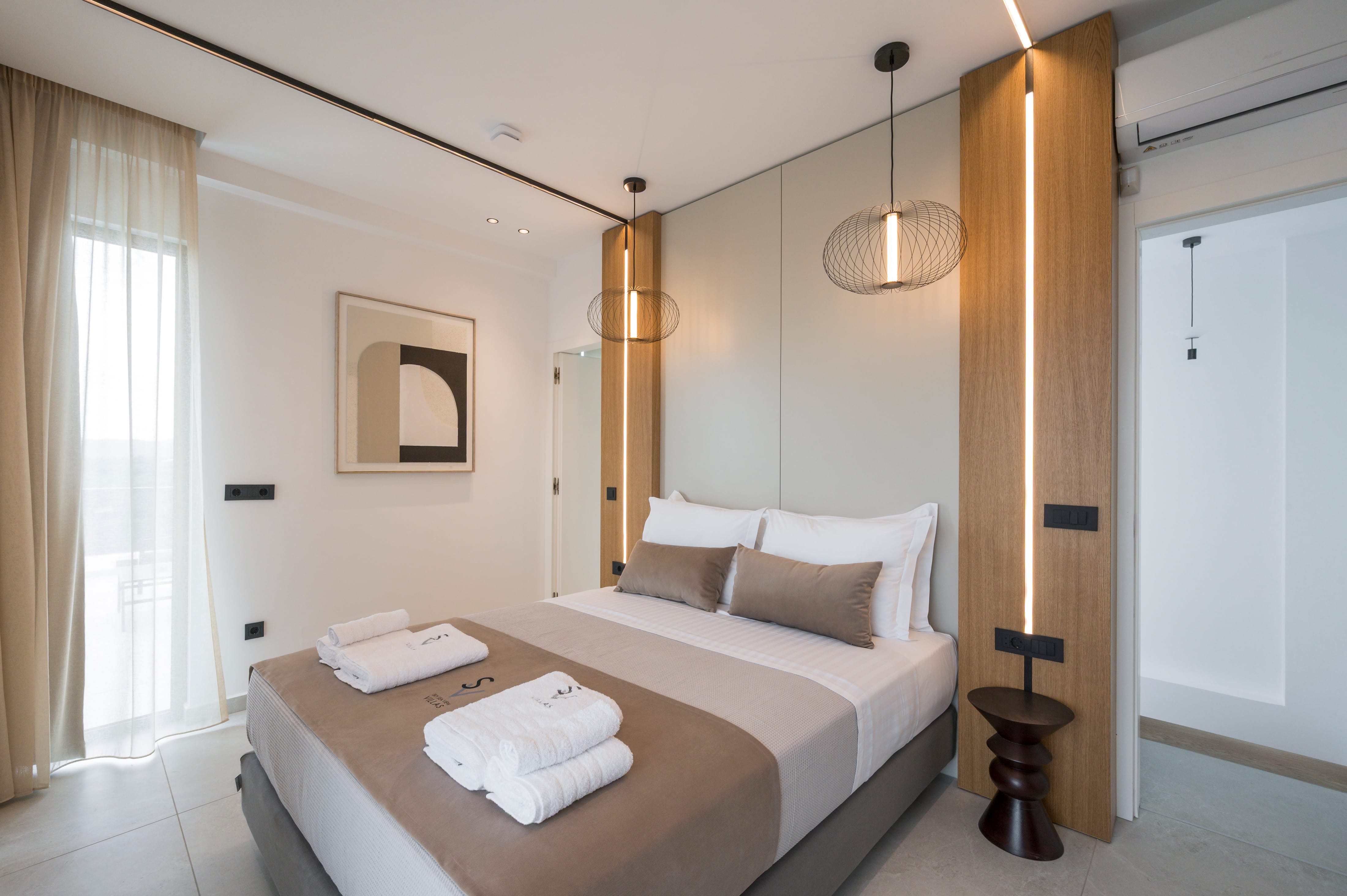 a bed with a brown blanket and white pillows