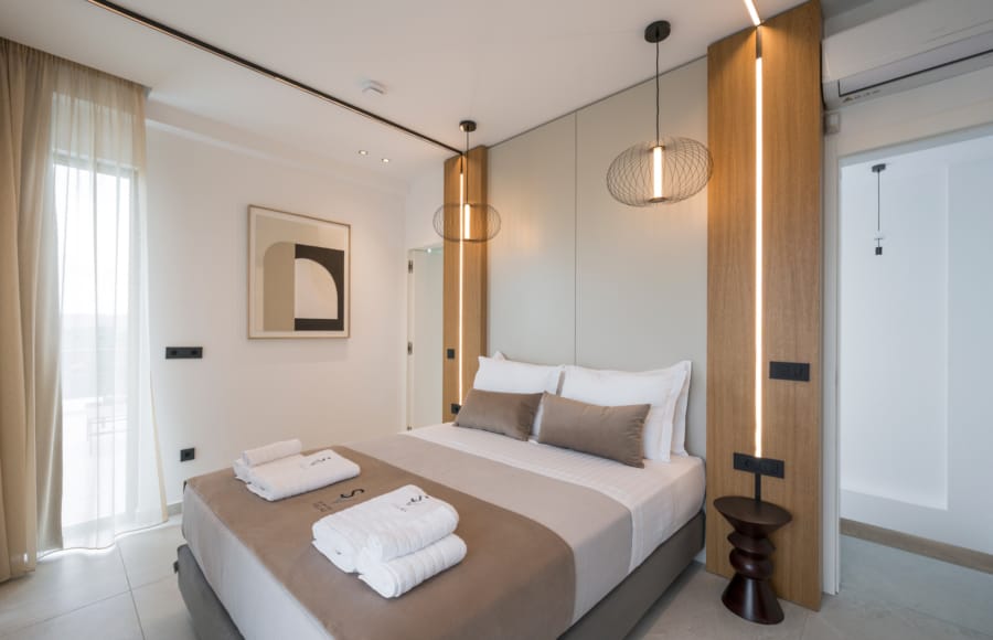 a bed with a brown blanket and white pillows