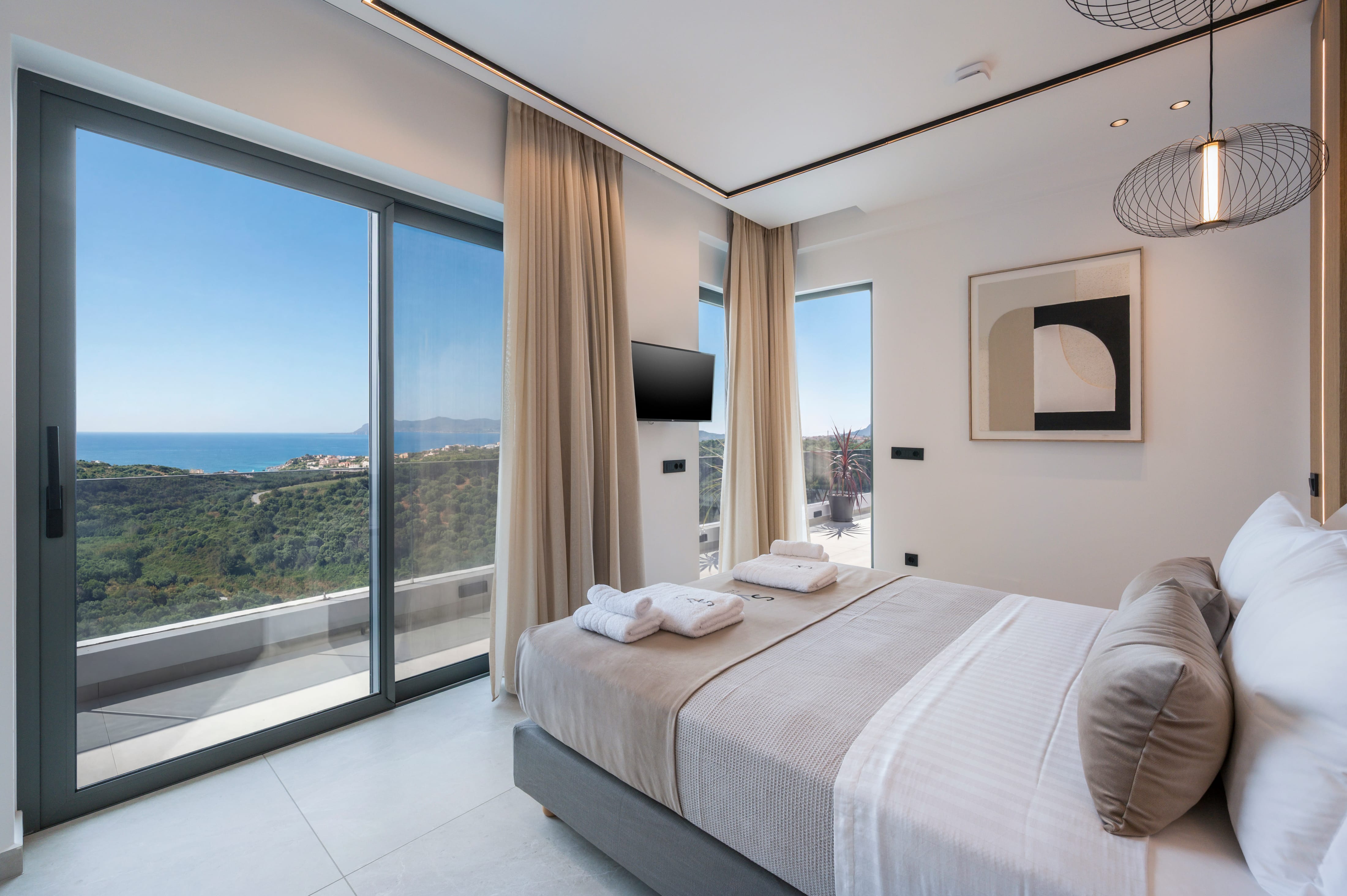 a bedroom with a view of the ocean