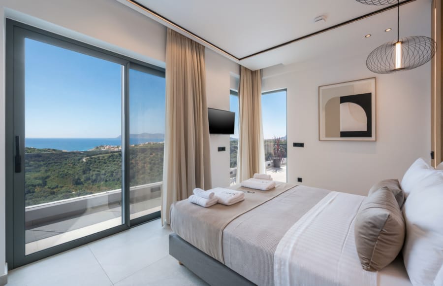 a bedroom with a view of the ocean