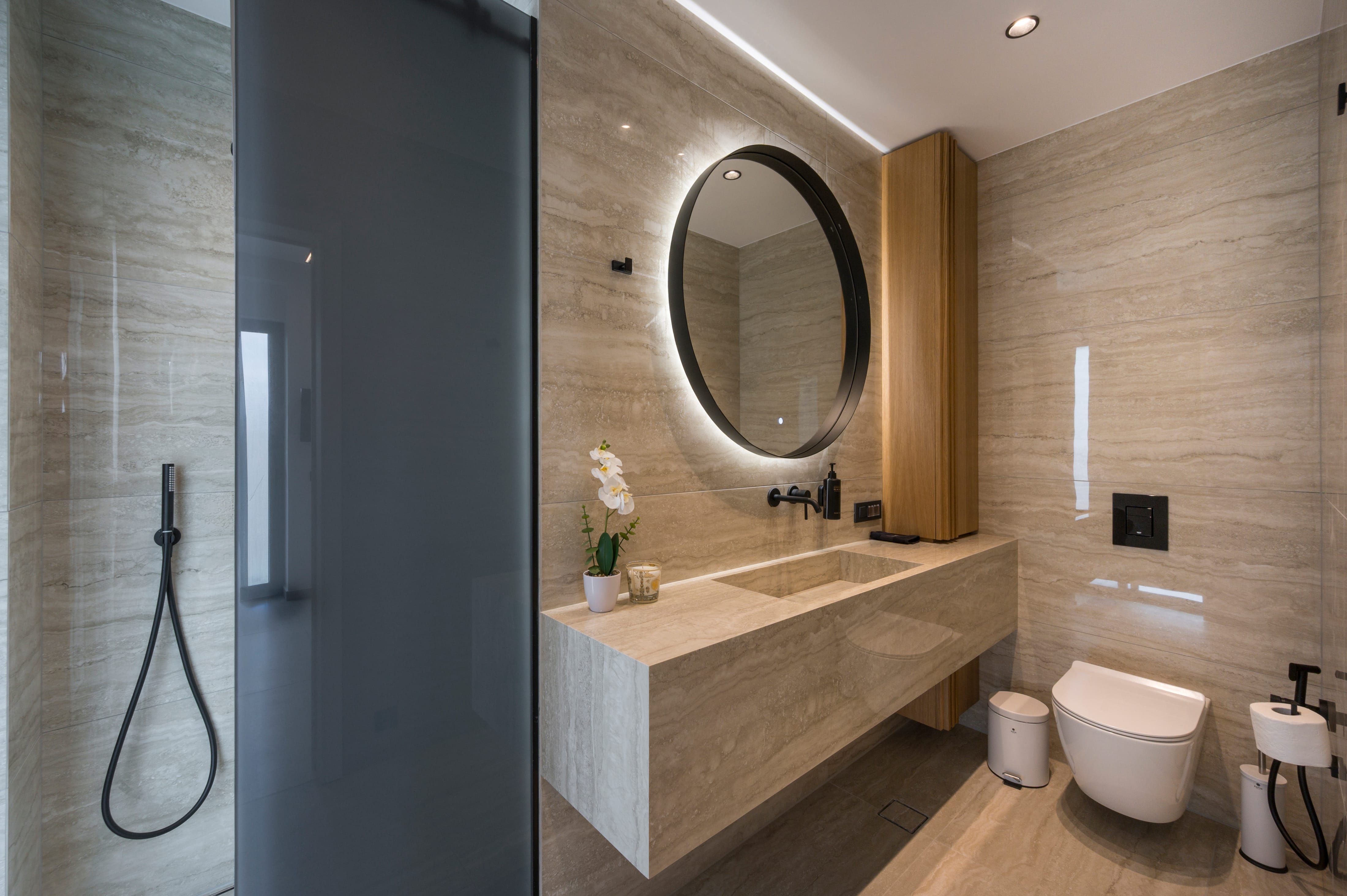 a bathroom with a round mirror