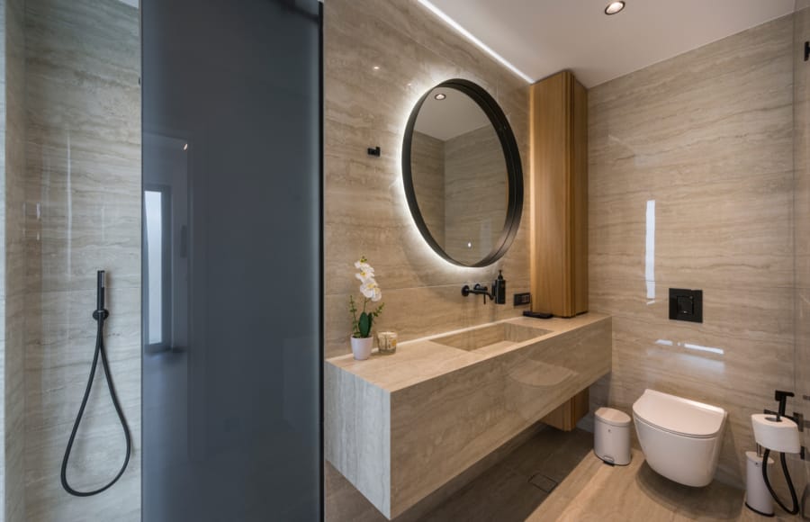 a bathroom with a round mirror