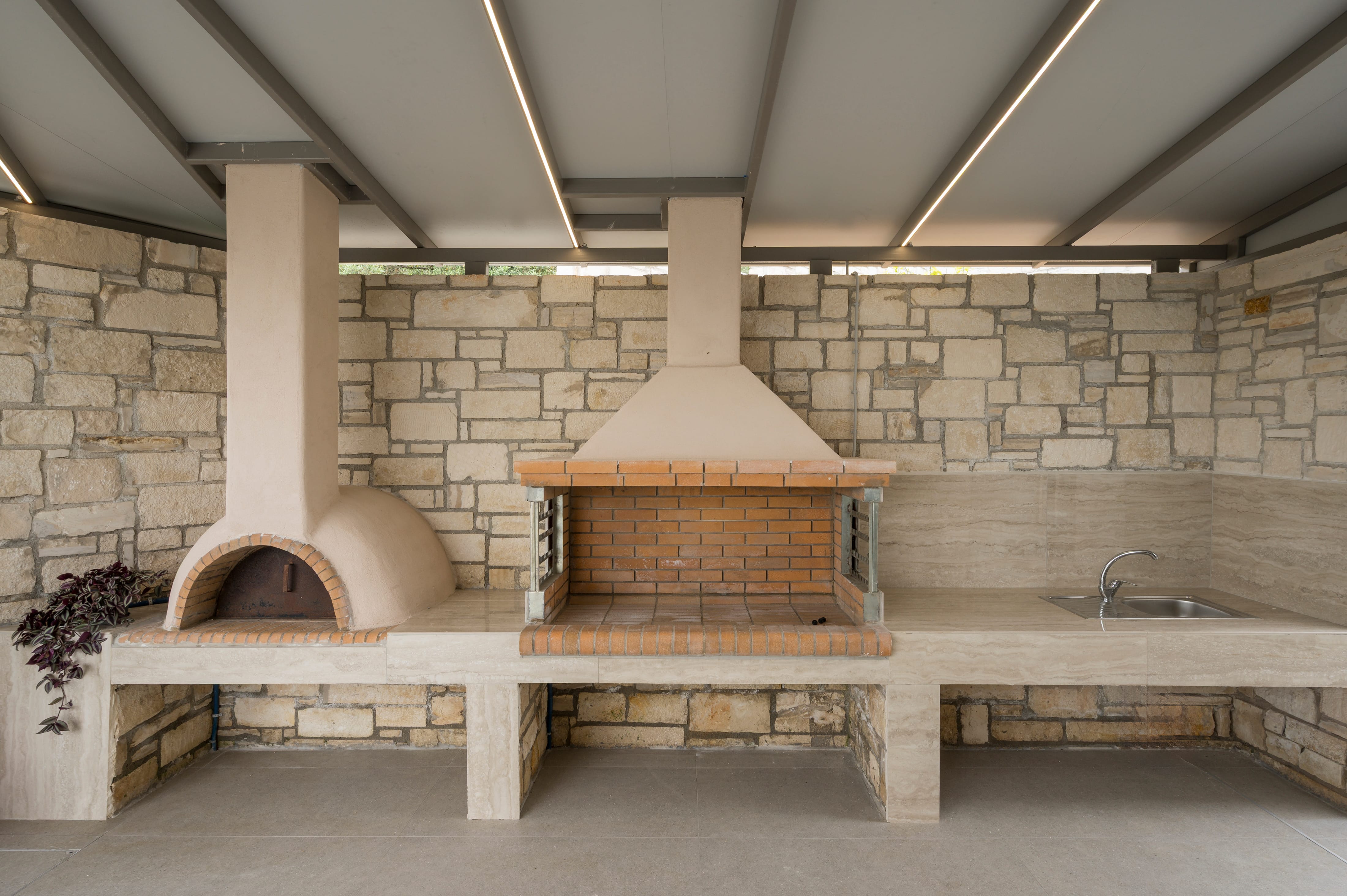 a stone patio with a brick oven