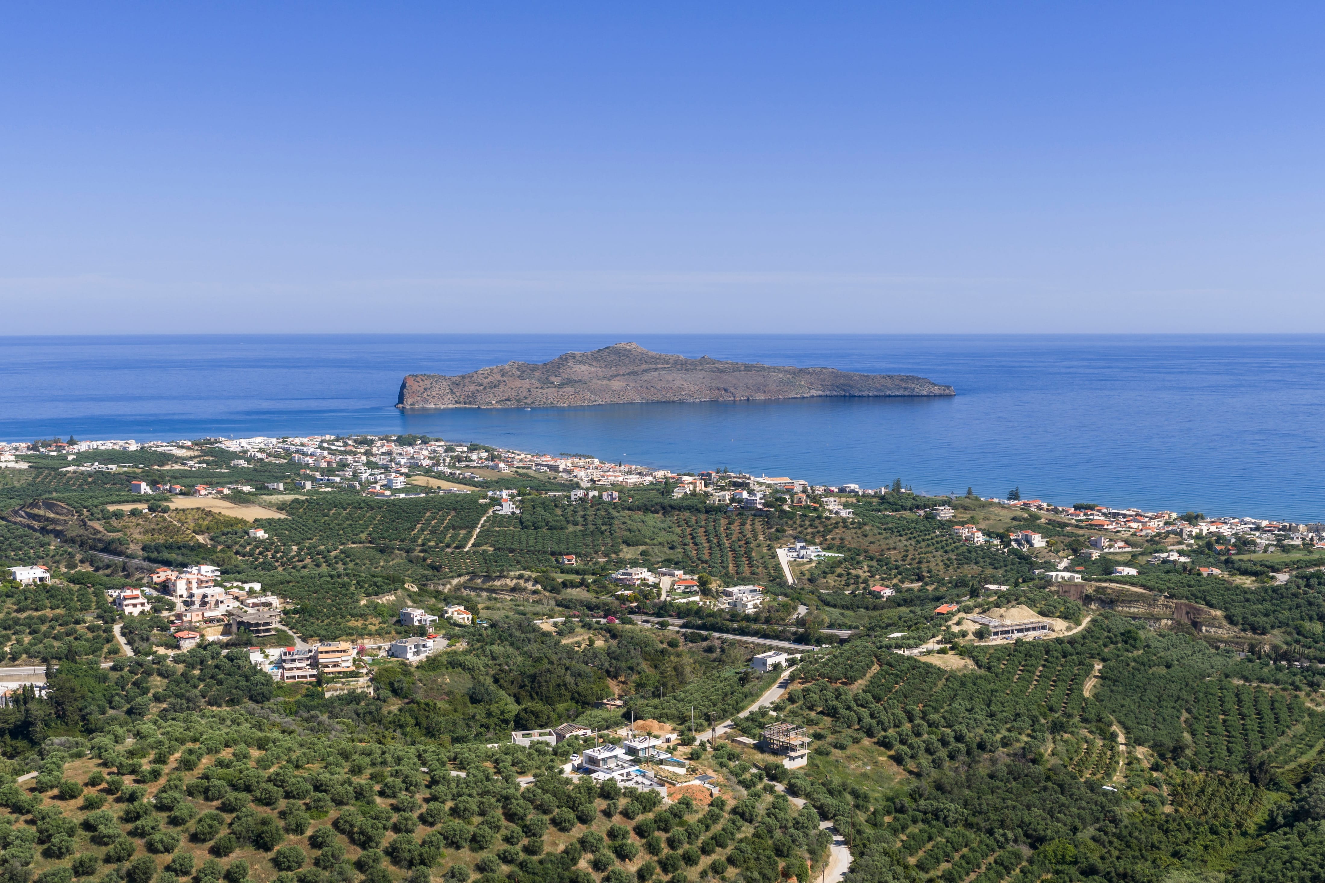 a landscape with a body of water and a city