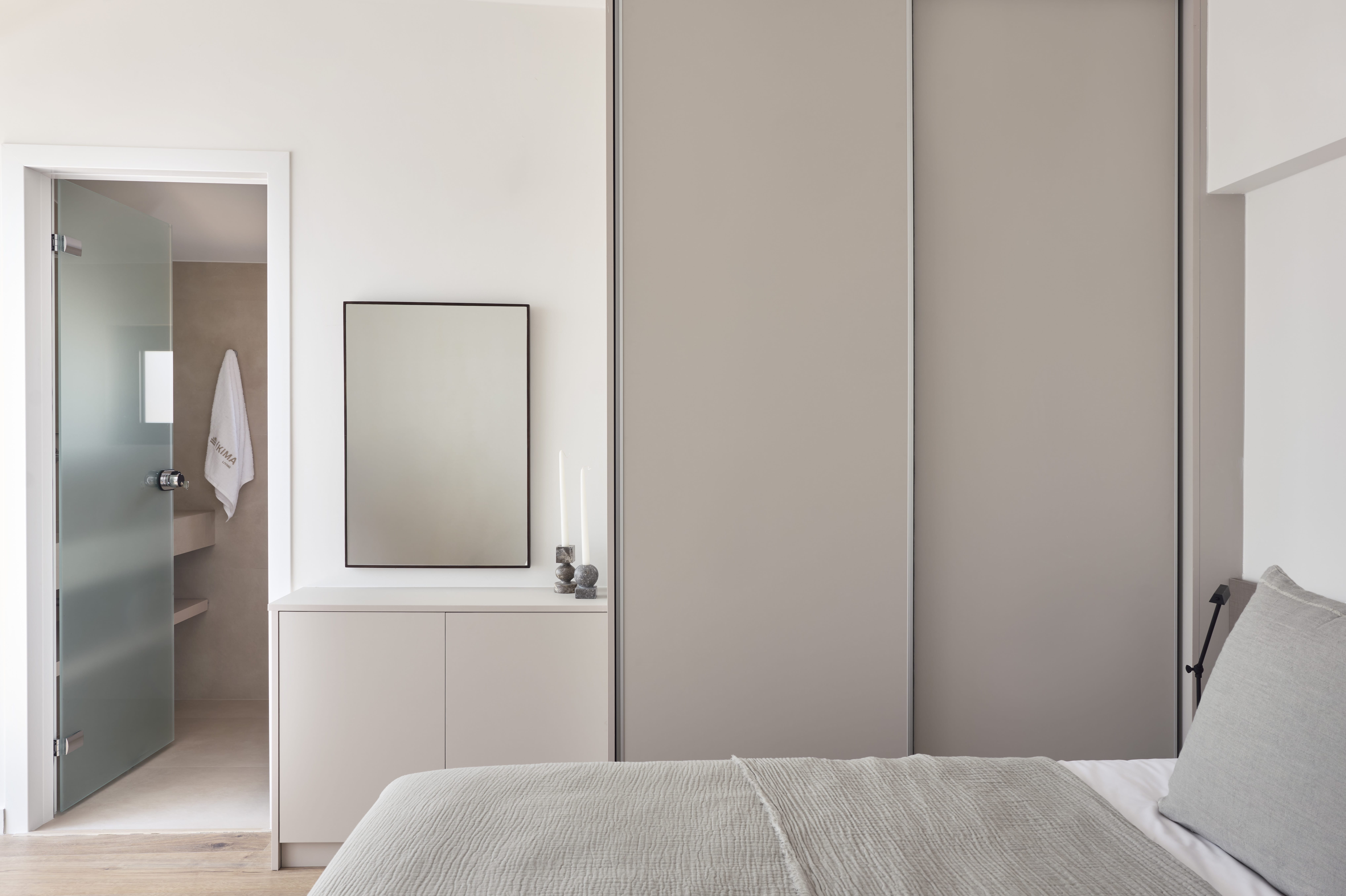 a bedroom with a mirror