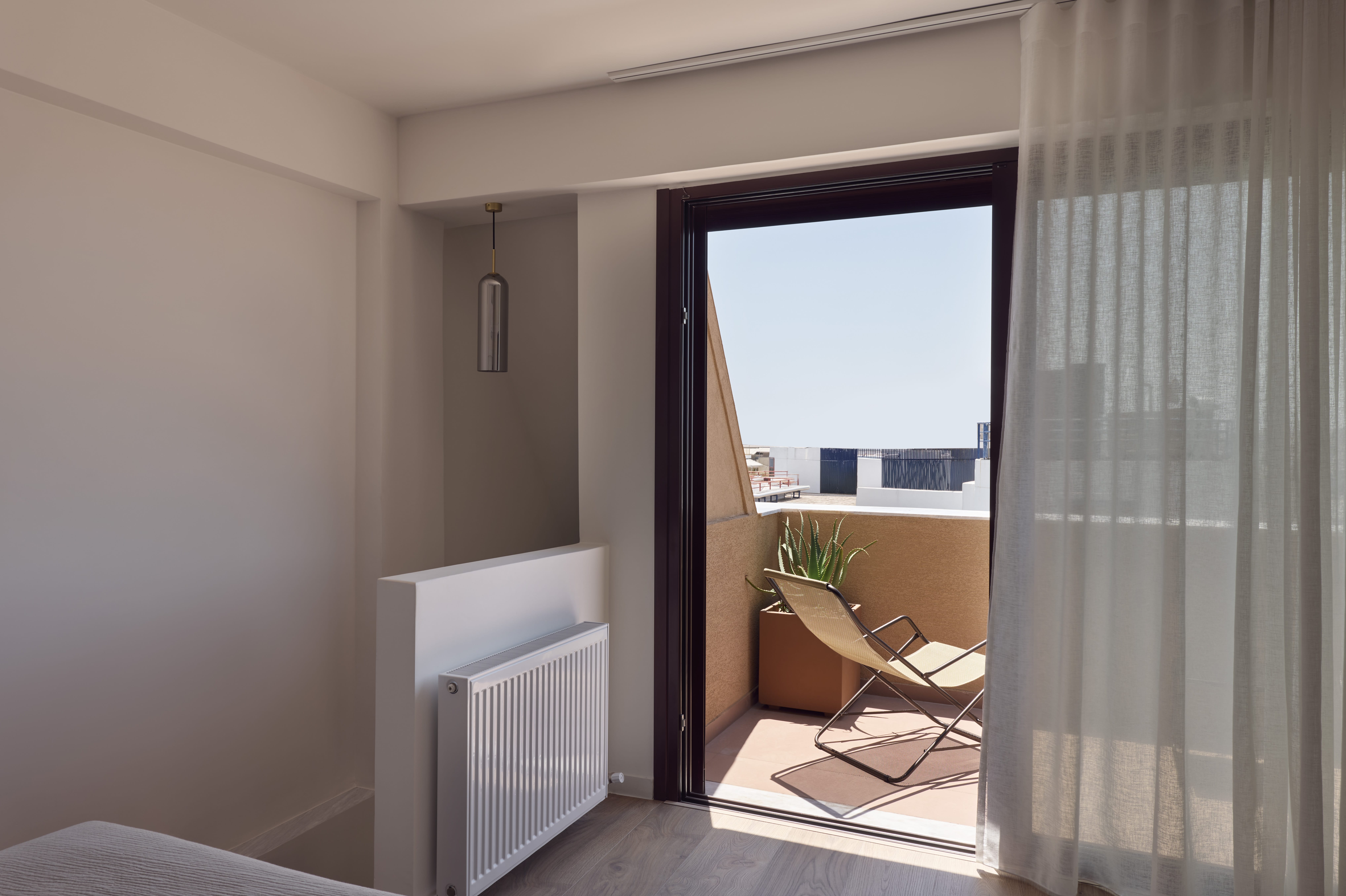 a room with a window and a chair