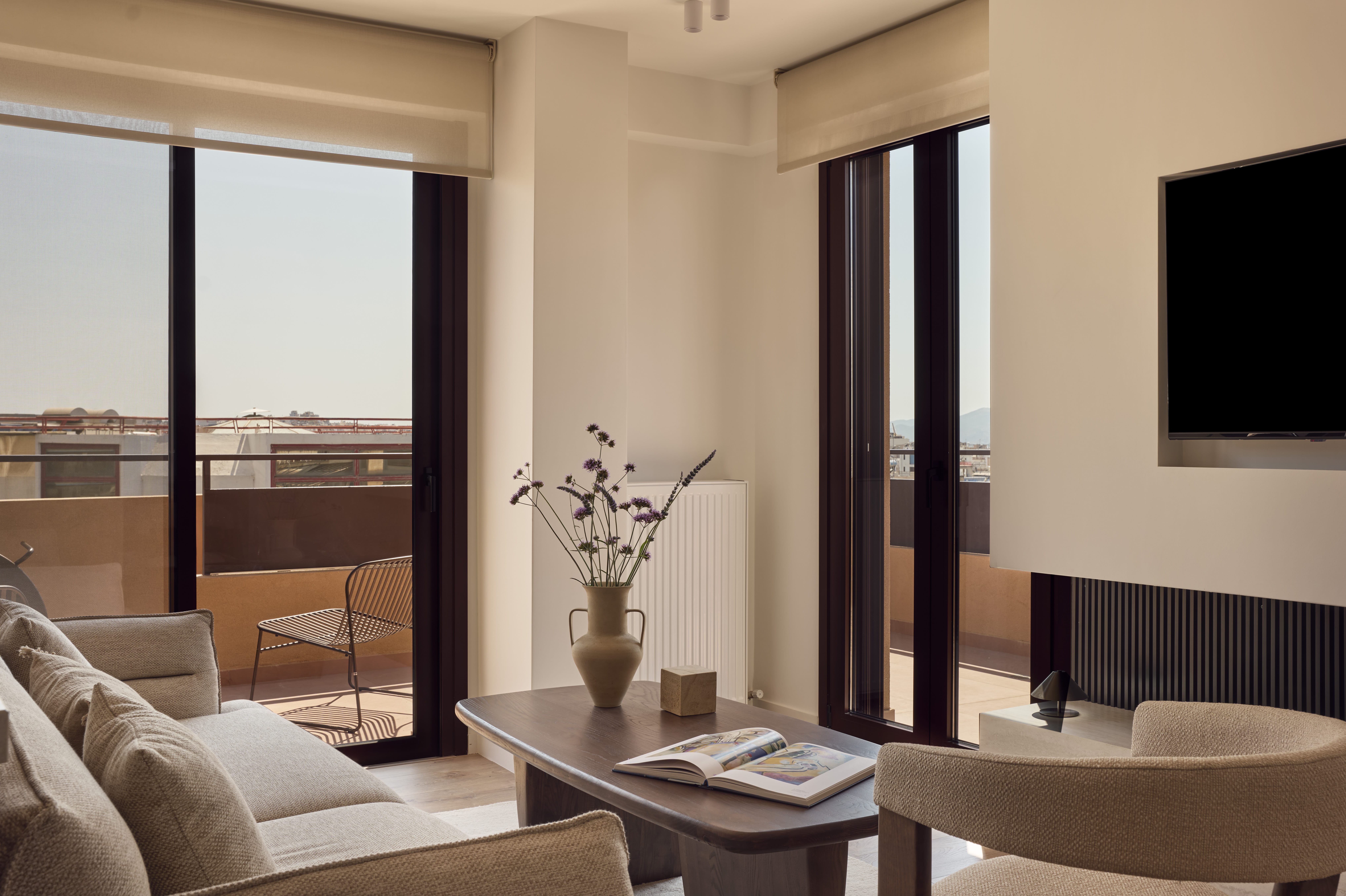 a living room with a tv and couches