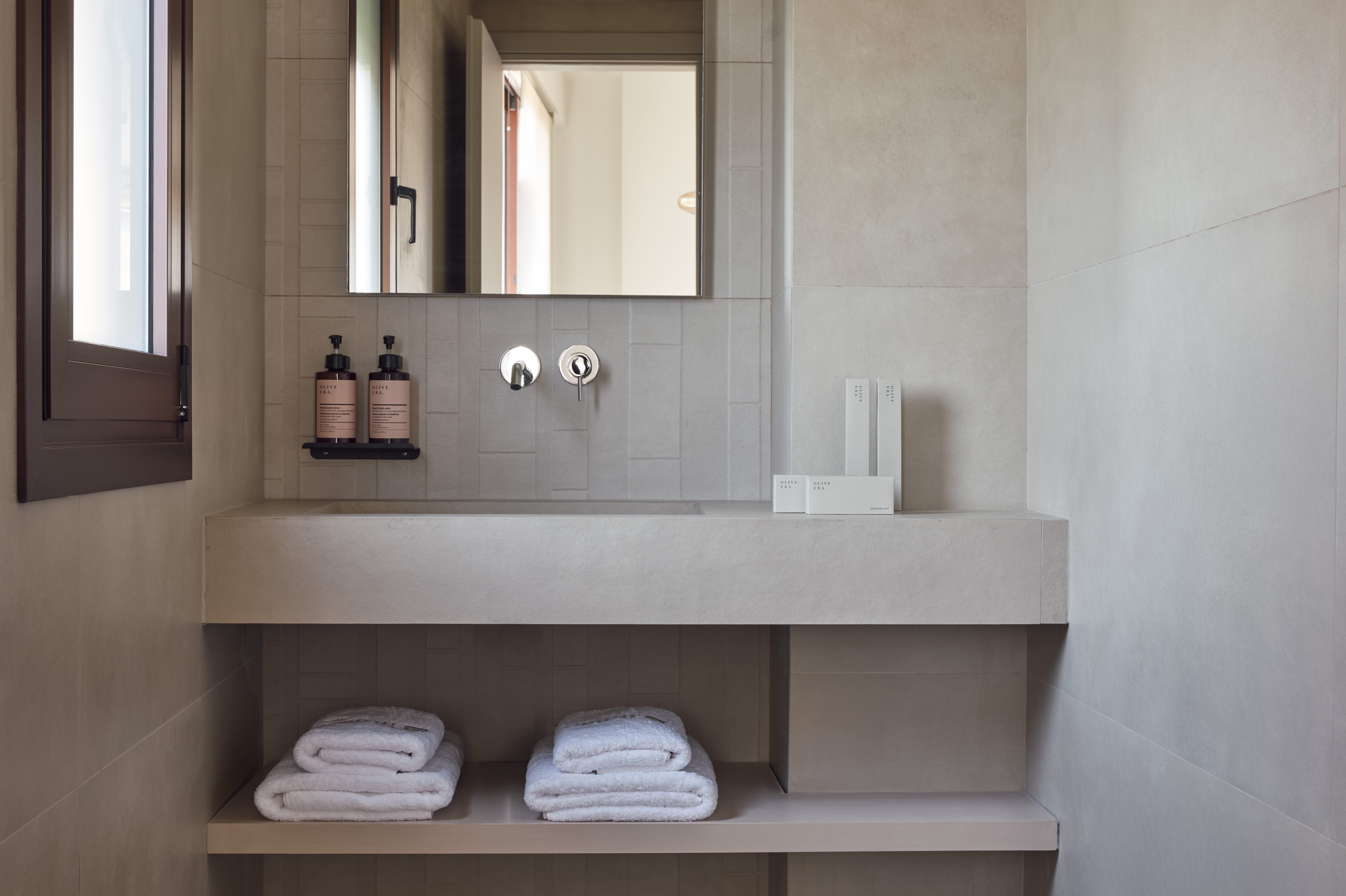 a bathroom with a mirror and towels