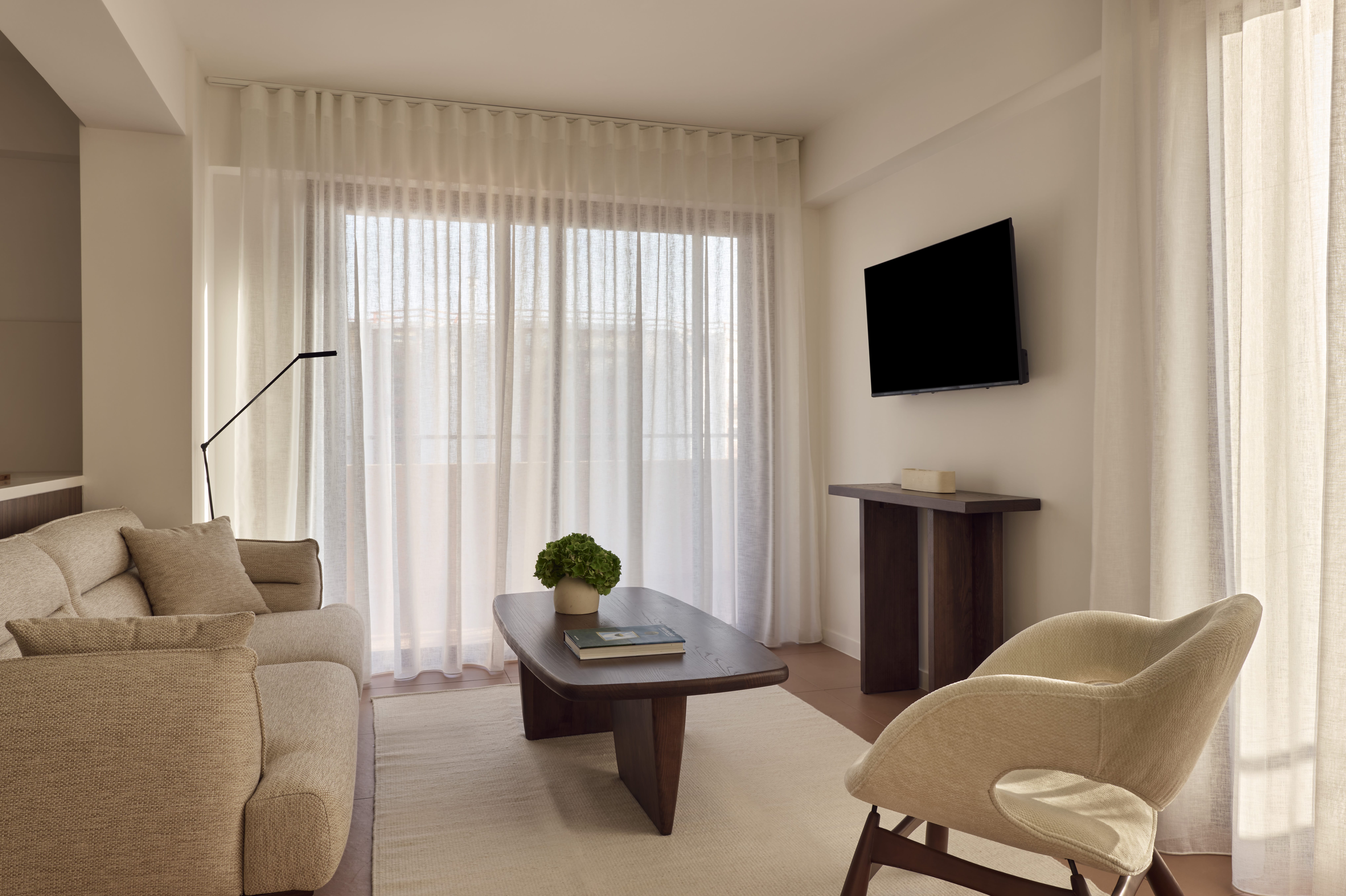 a living room with a tv and couches