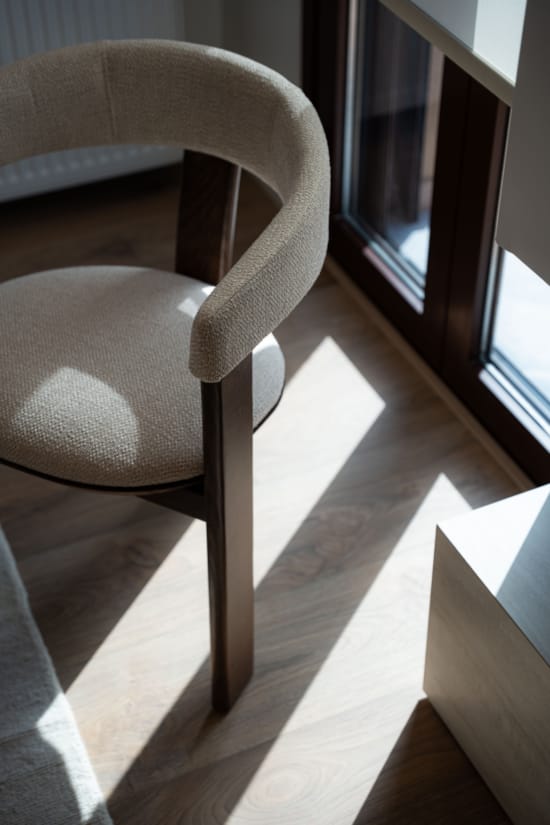 a couple of chairs by a window