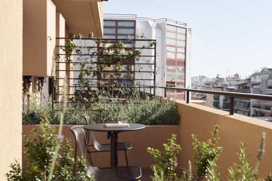 a table and chairs on a balcony