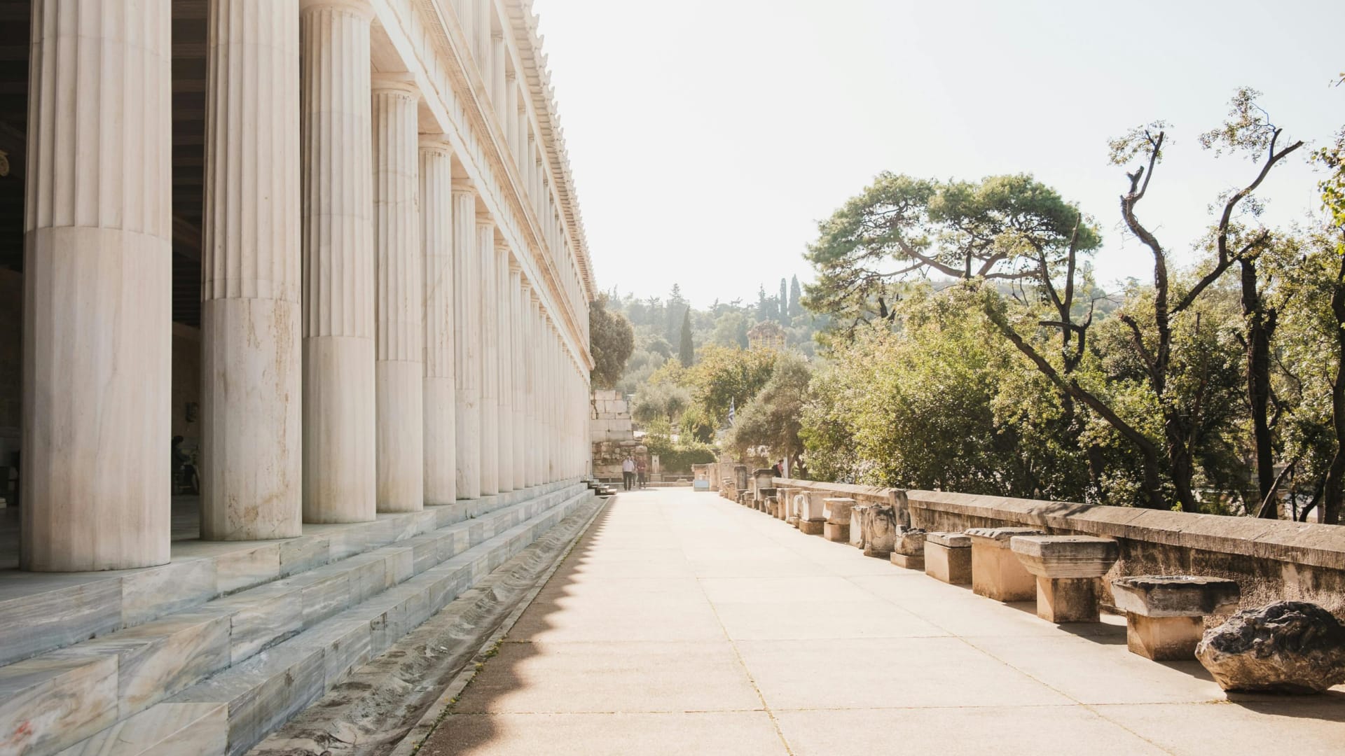 a concrete walkway with pillars
