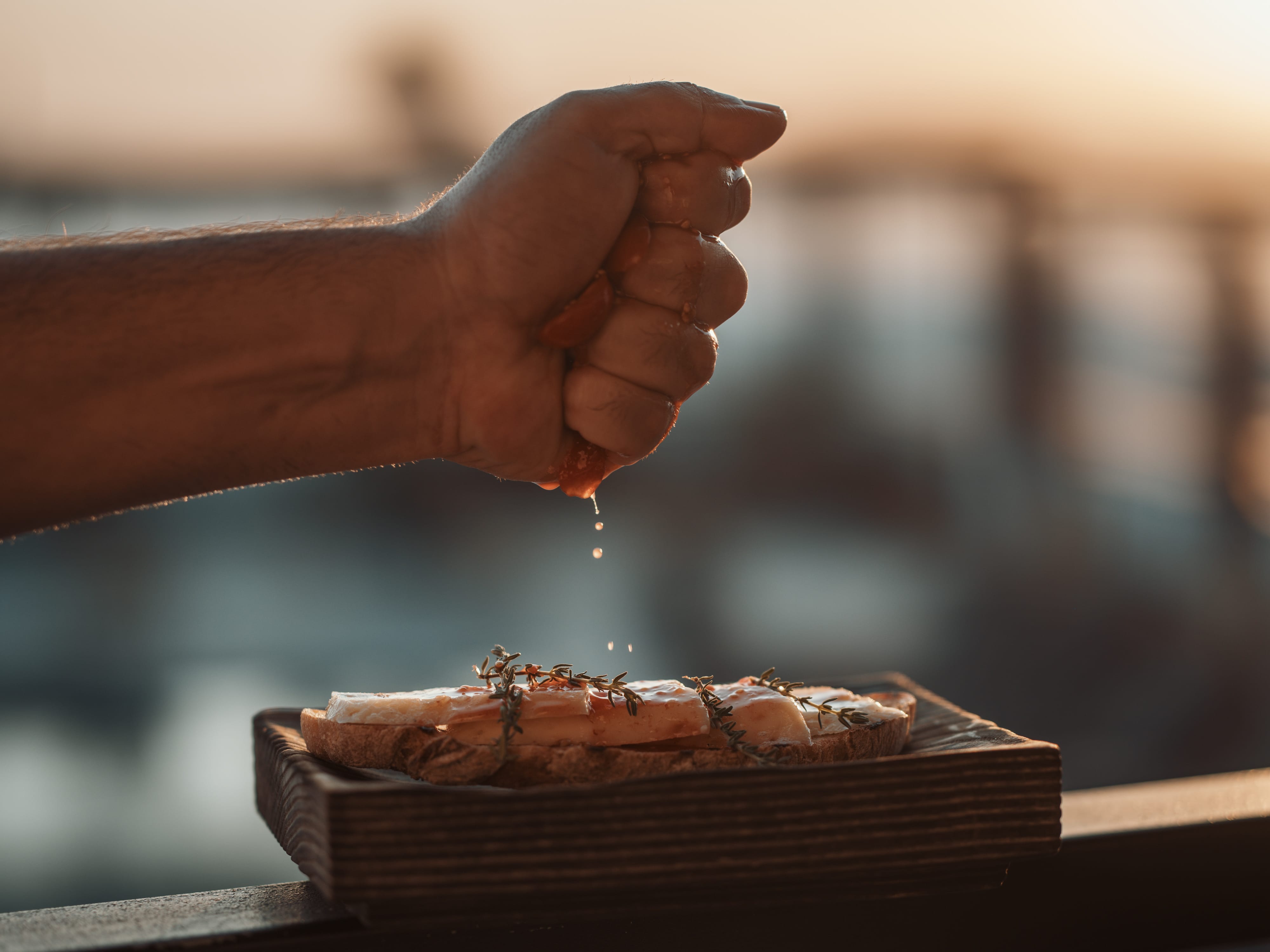 a hand pouring water into a basket