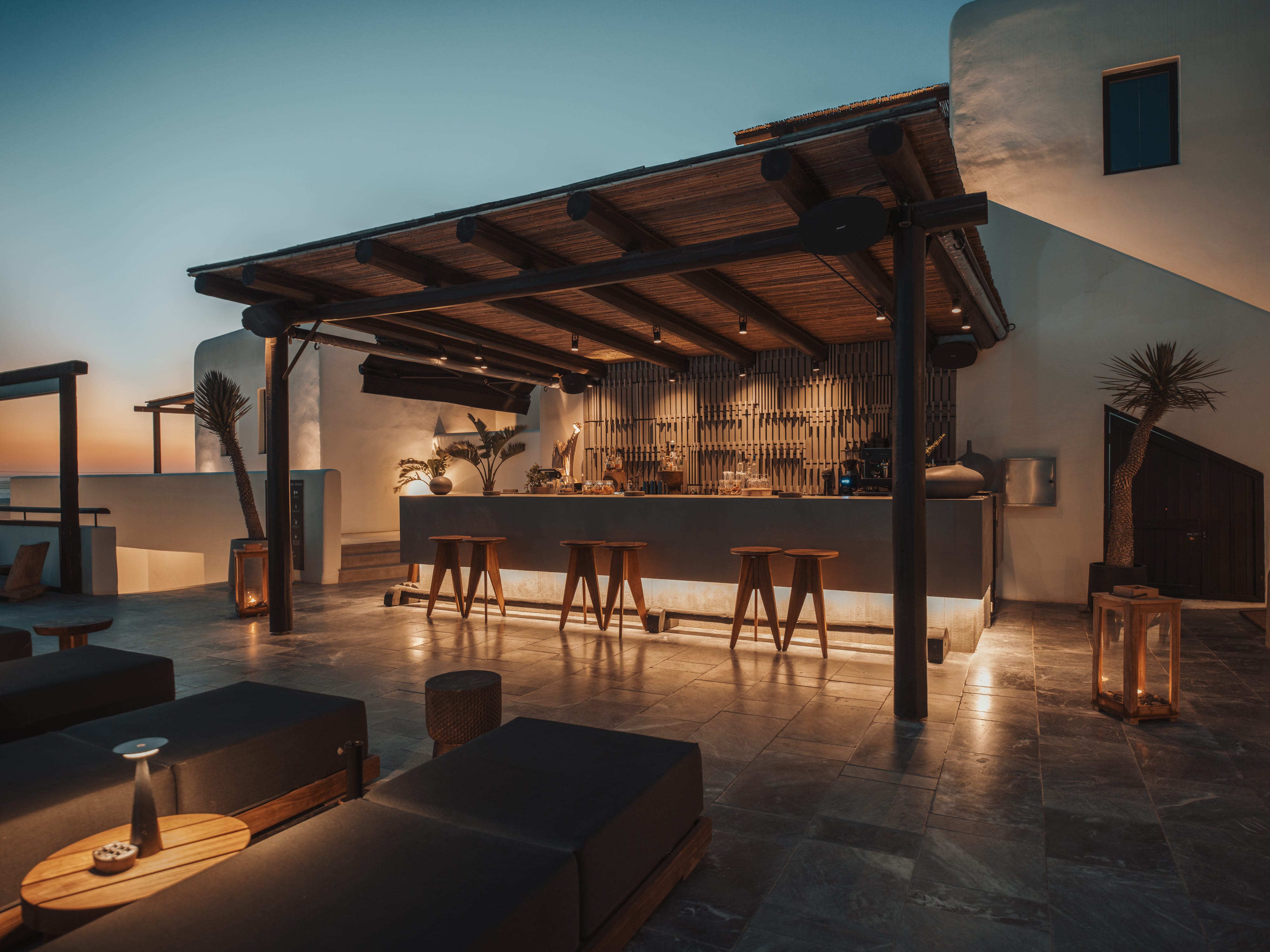 a bar with stools and tables