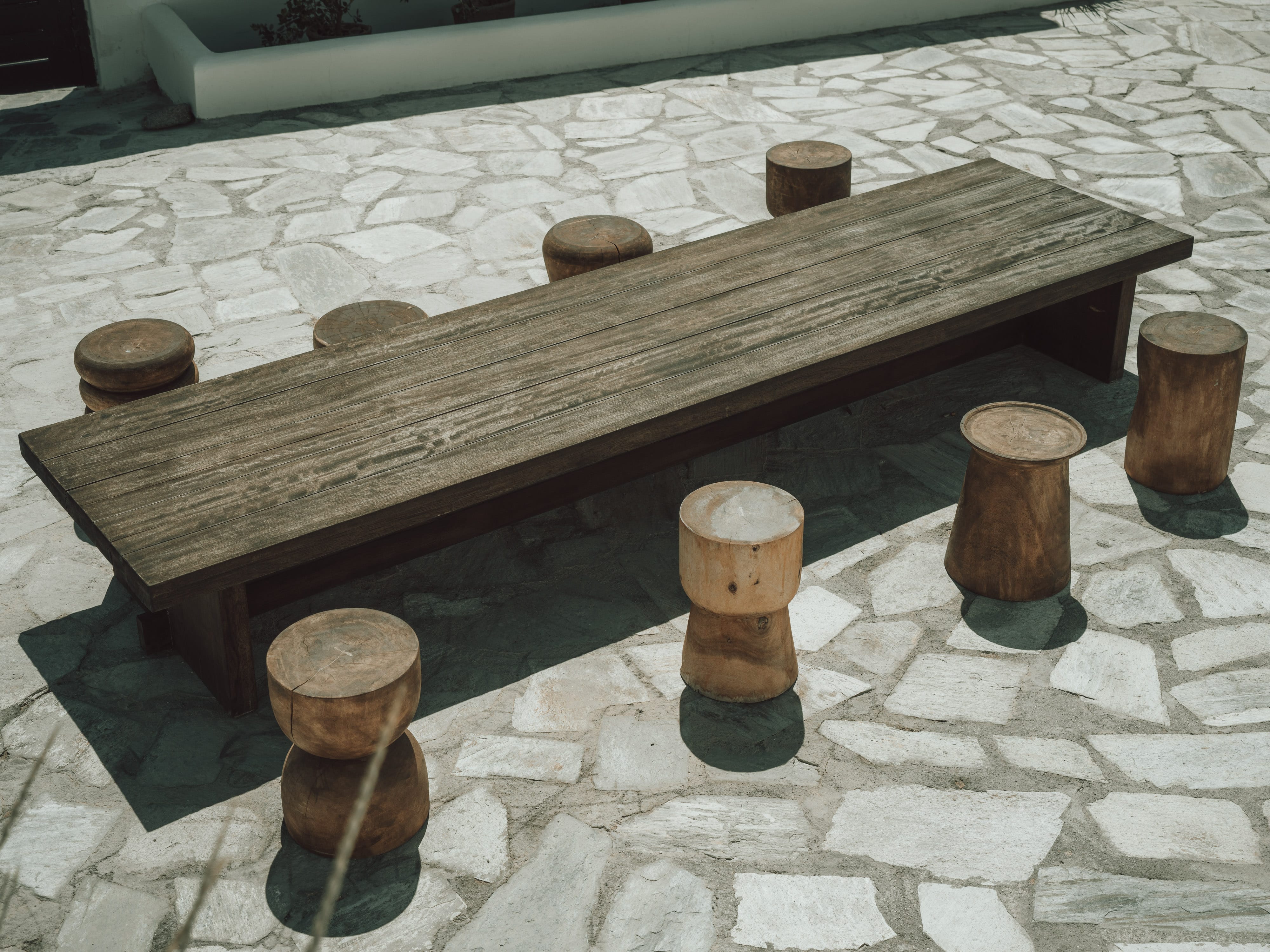 a wooden chess board on a stone surface