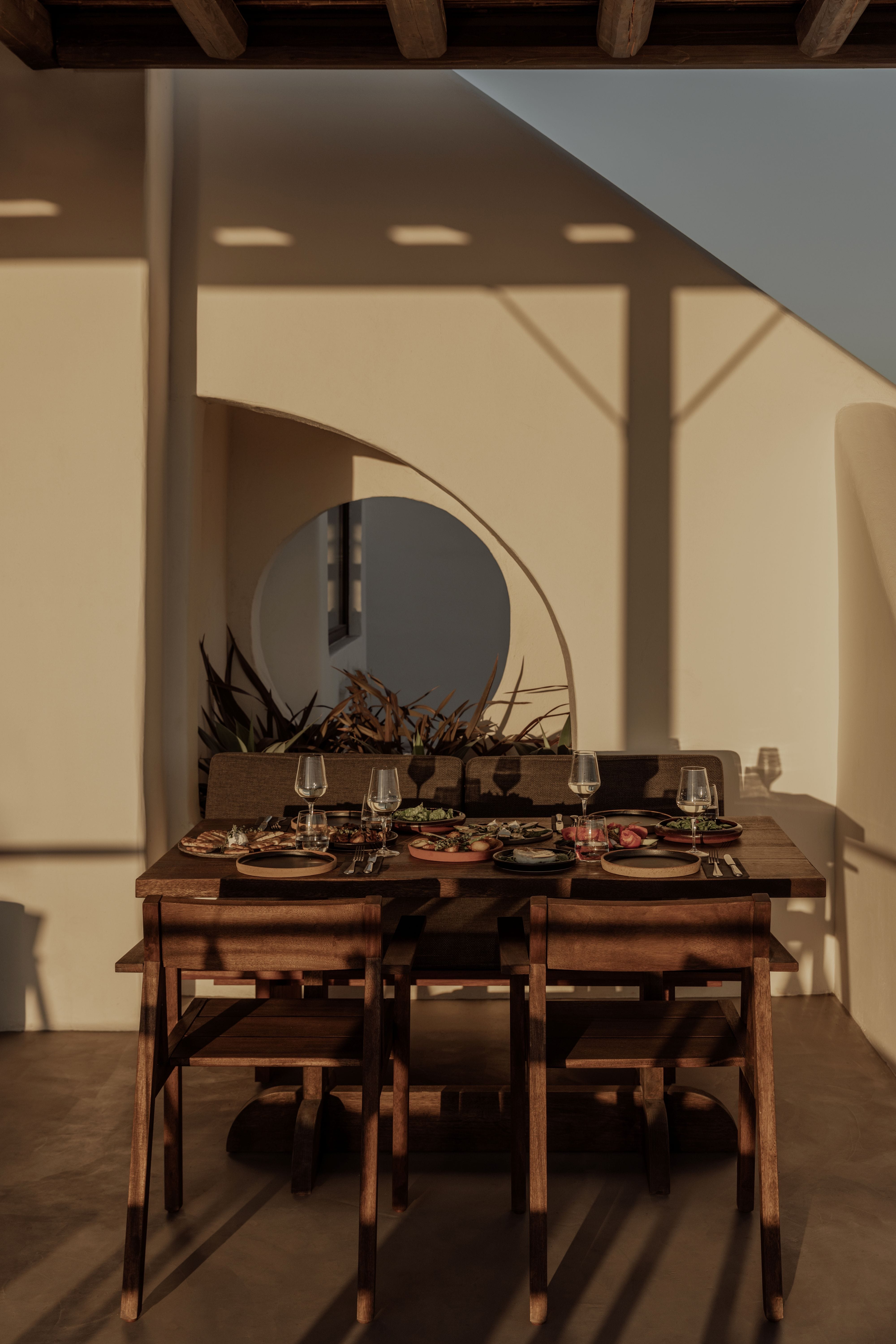 a dining table with plates and glasses