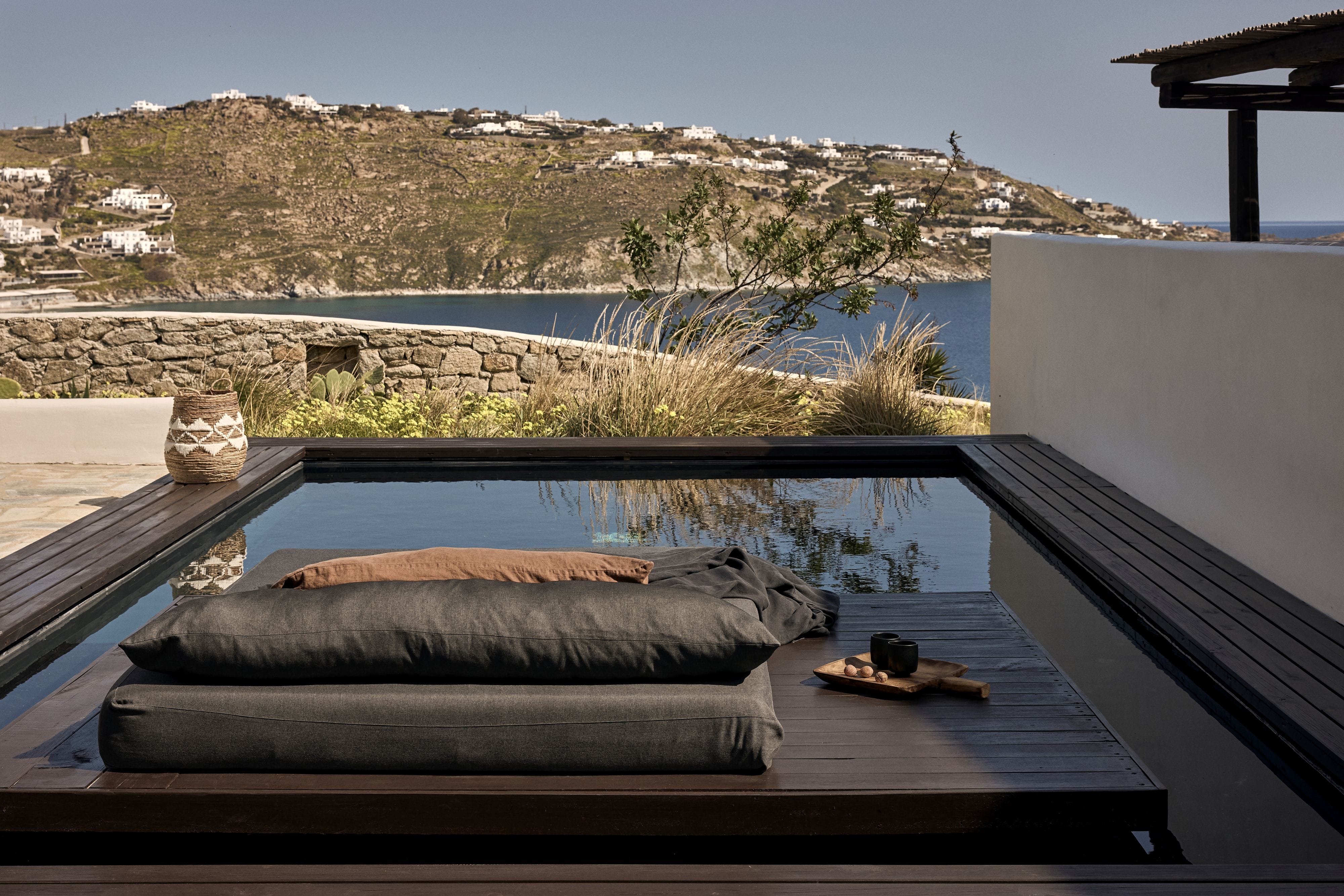 a deck with a view of a lake and mountains