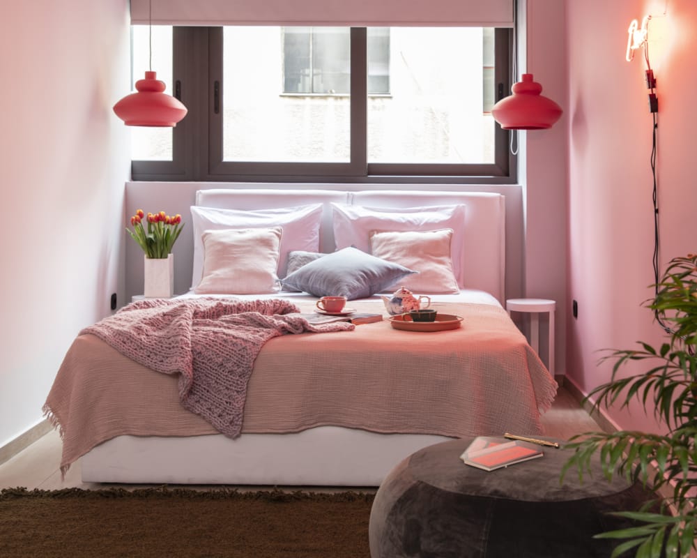 a bed with a pink comforter
