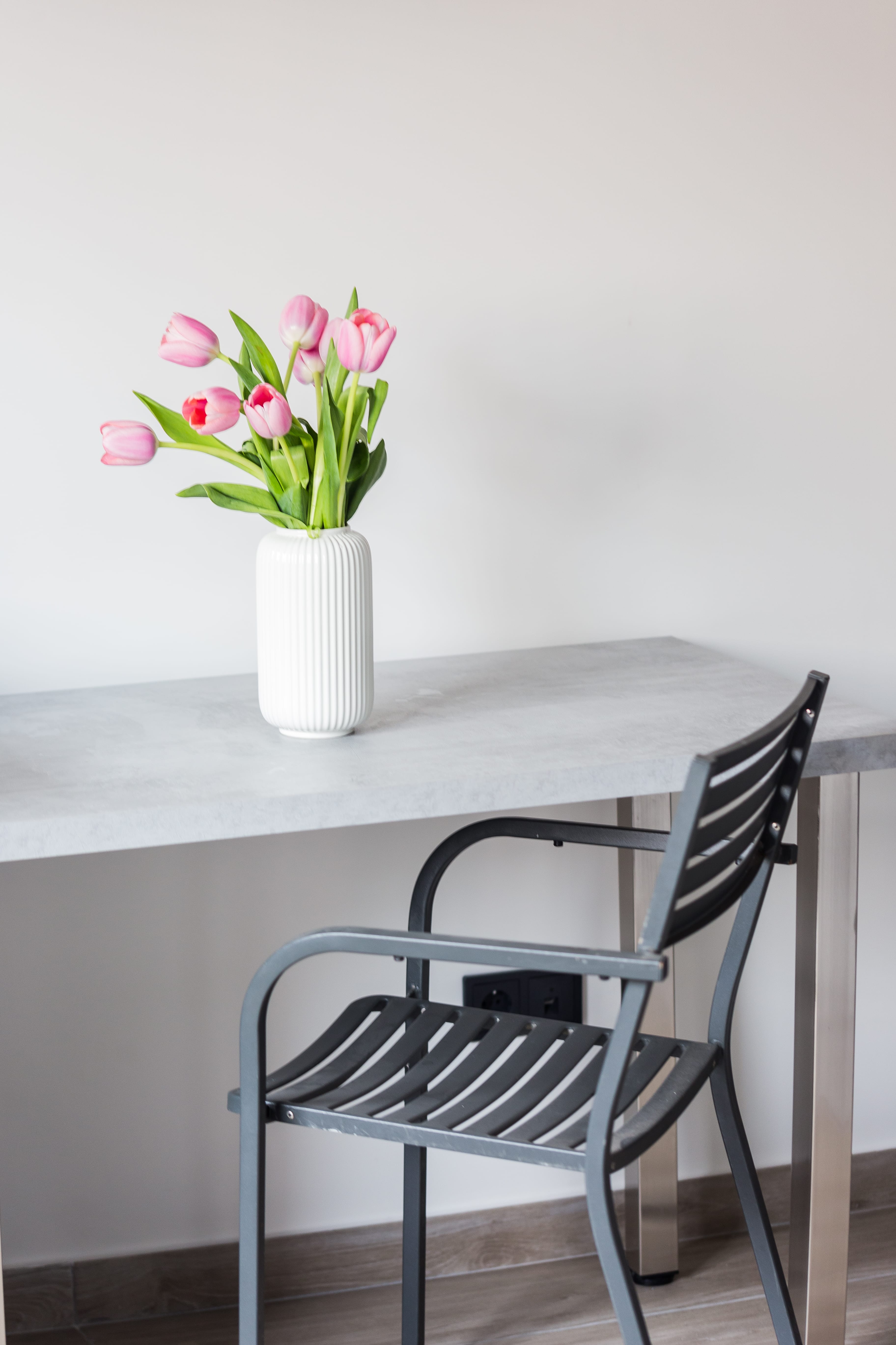 a vase of pink flowers on a table