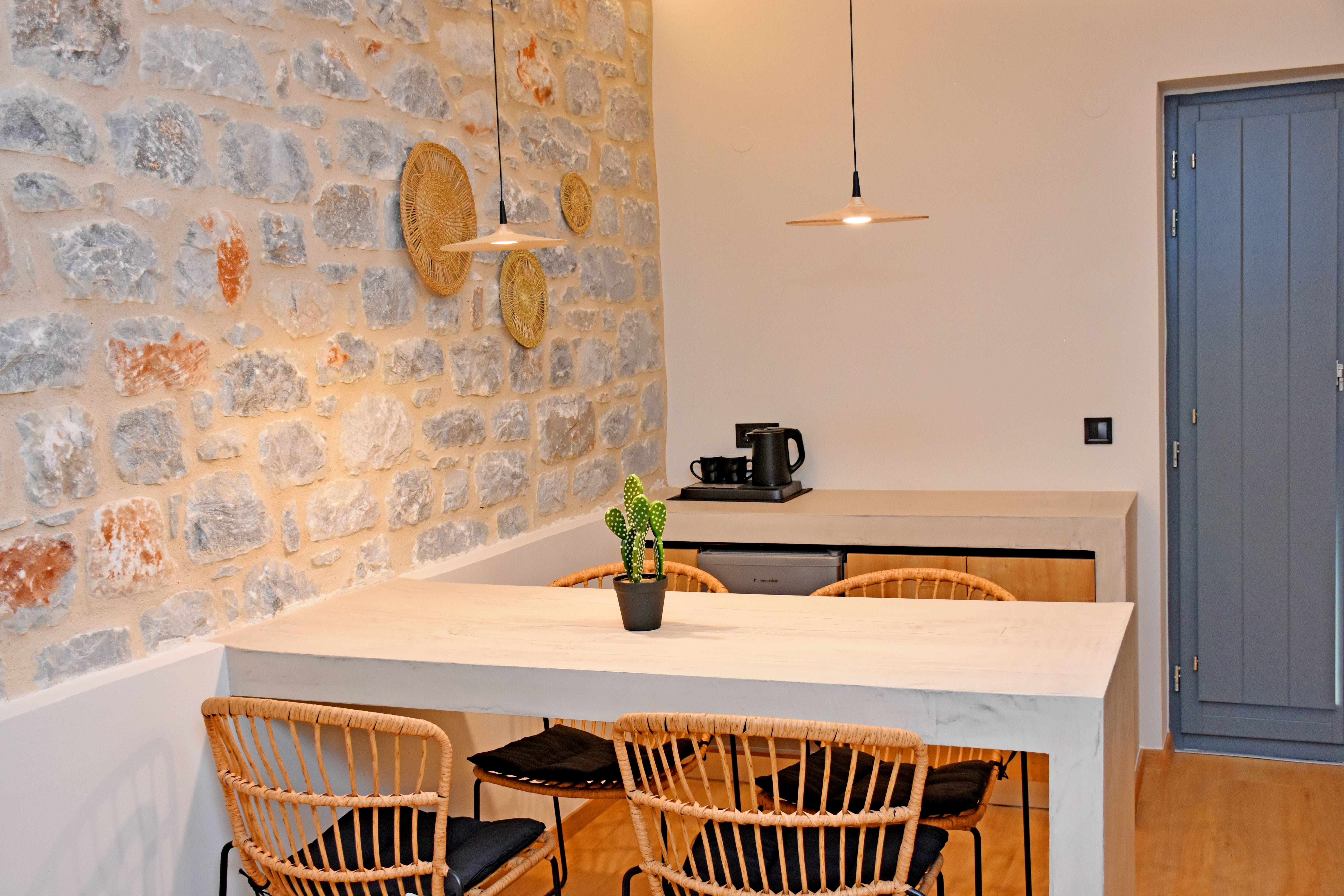 a table with chairs and a plant on it