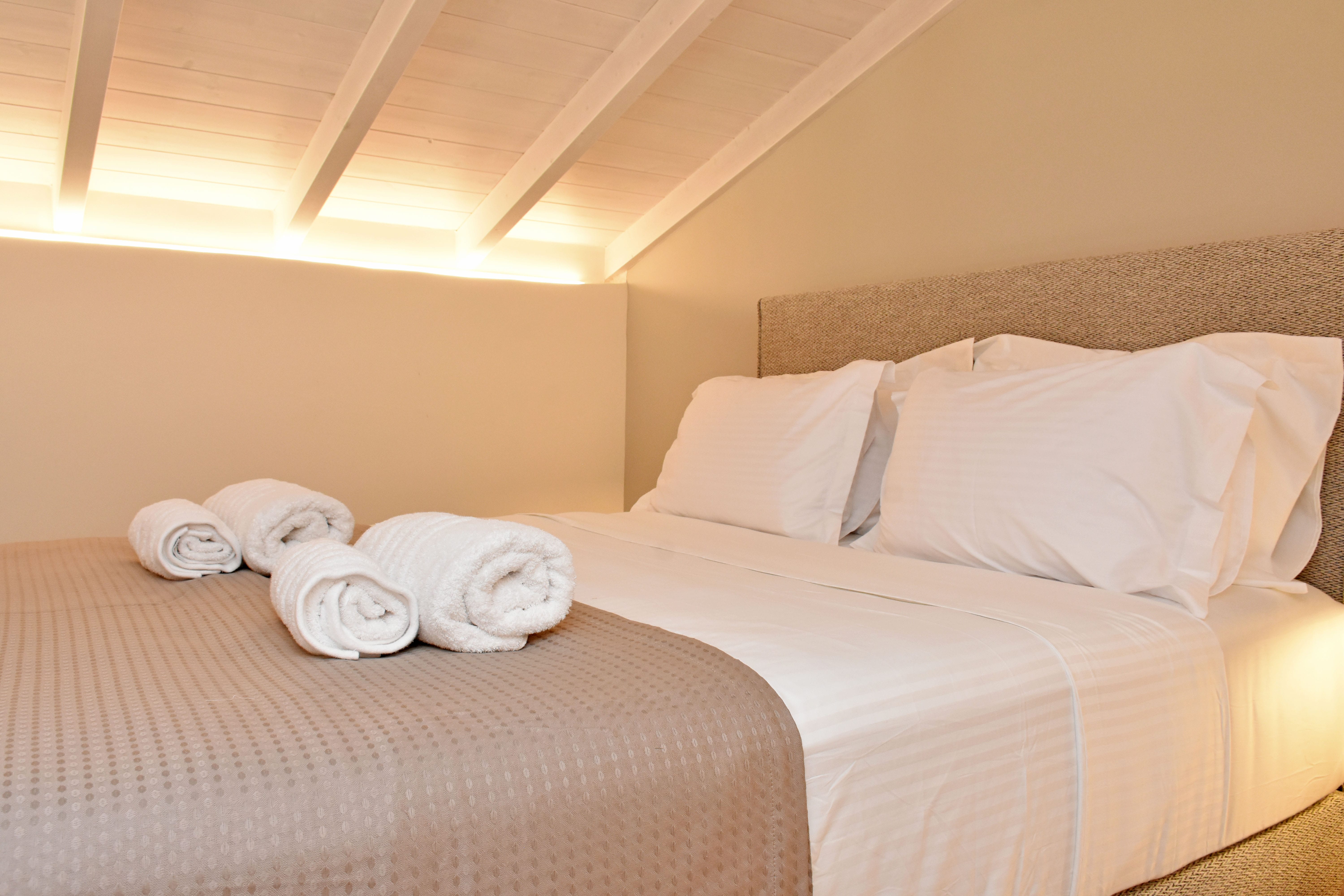 a couple of beds with towels on them