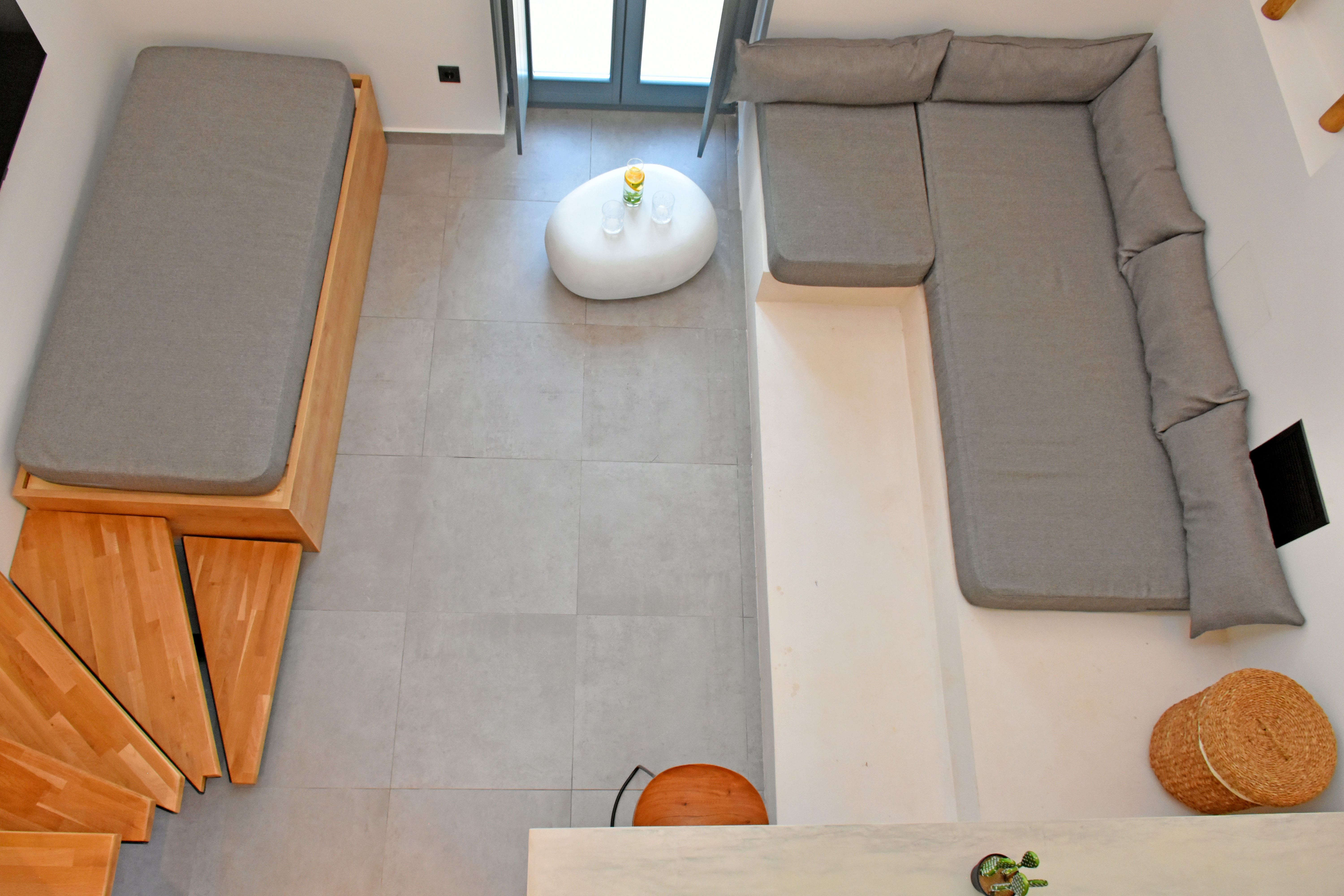 a room with a white couch and a white table with a white ball on it