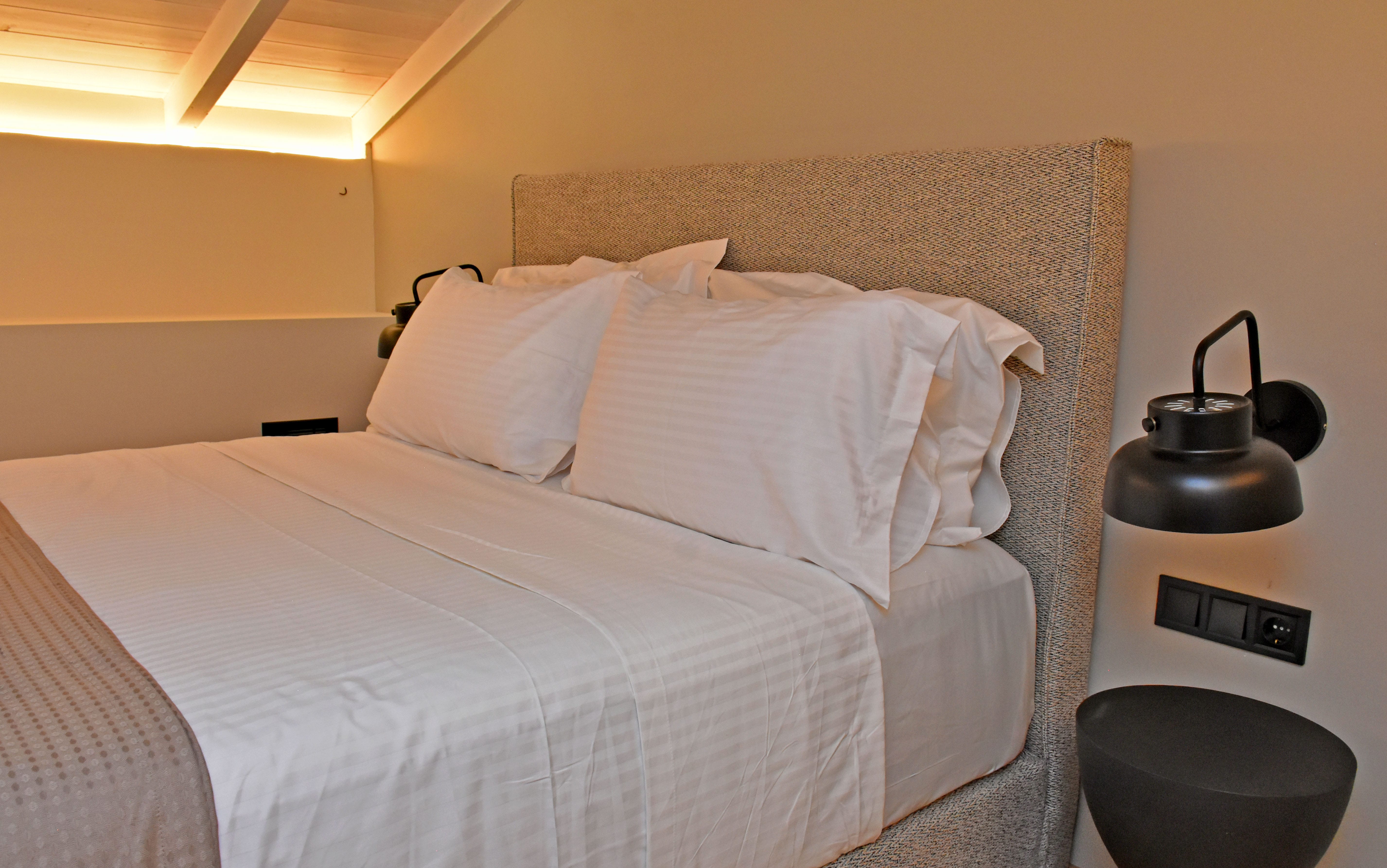 a bed with a white comforter