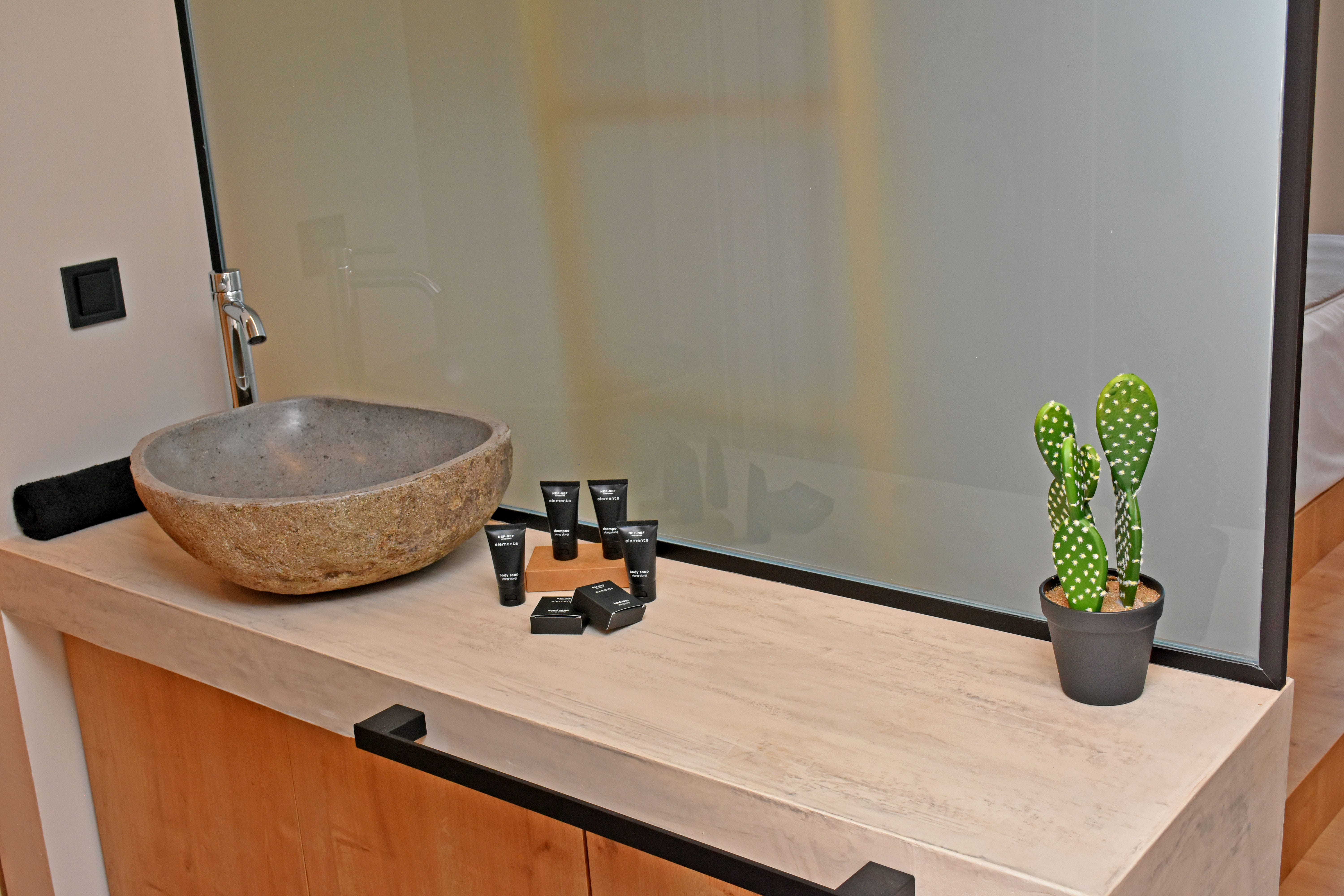 a counter top with a plant and a bowl on it