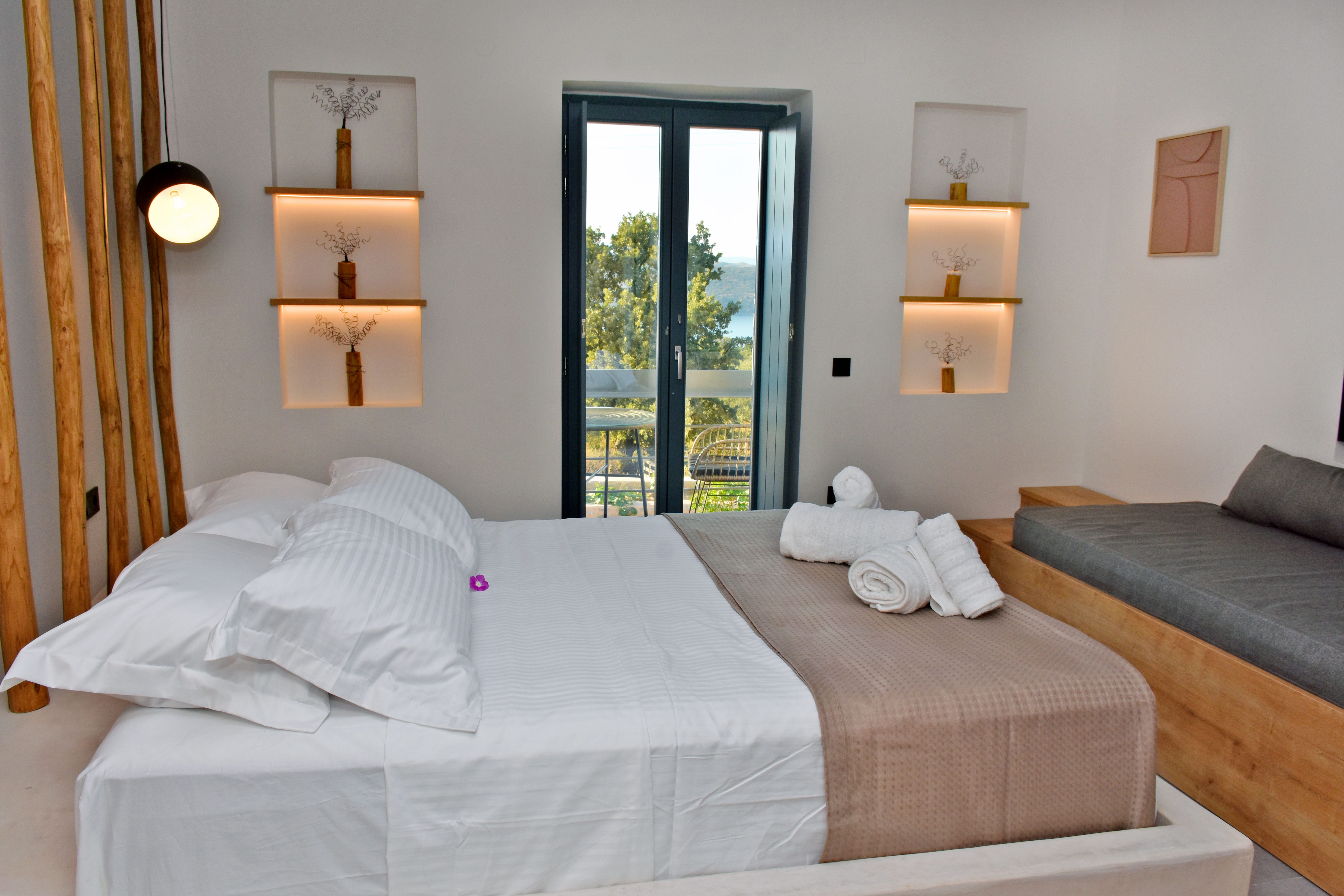 a bed with white sheets and pillows