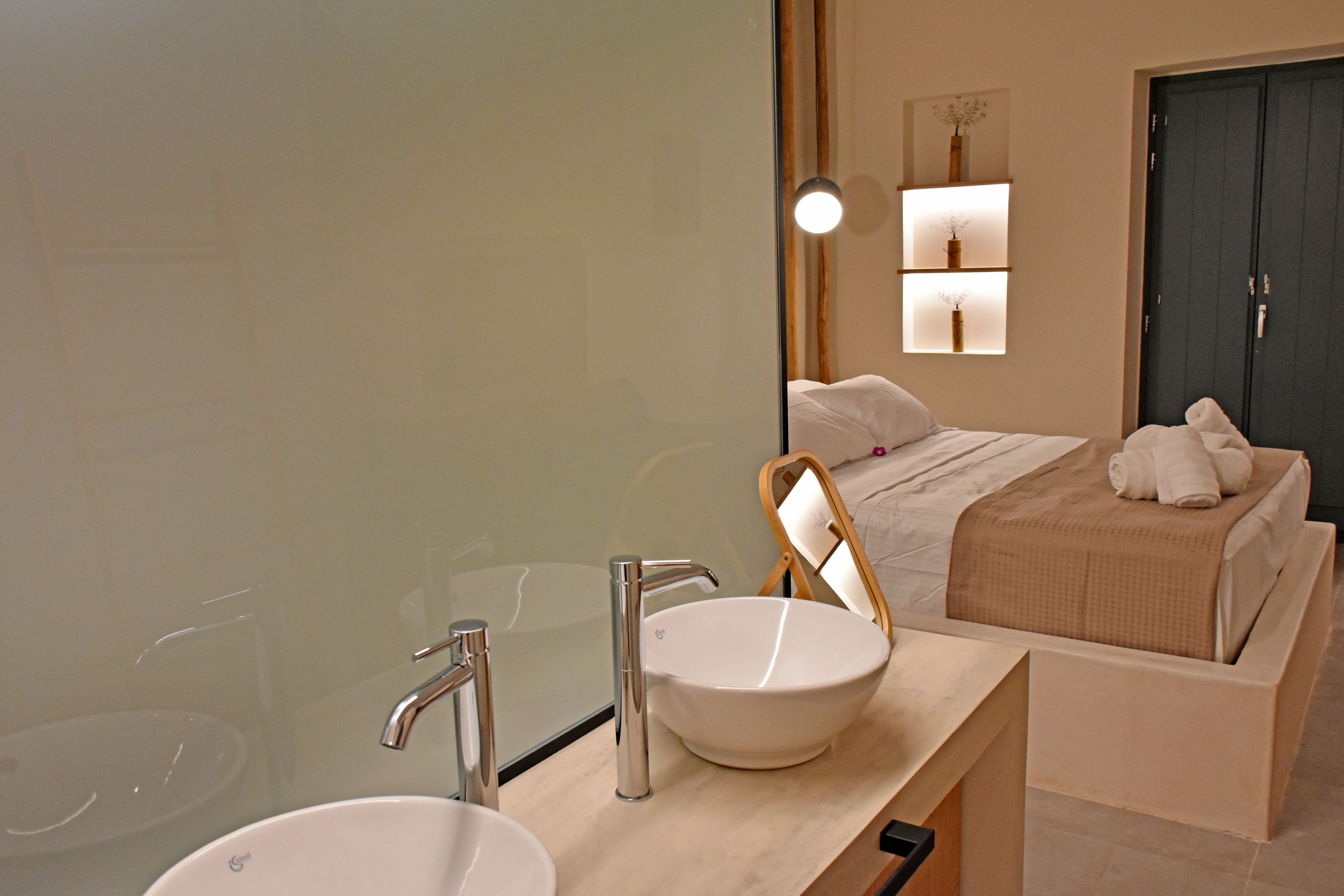 a bathroom with a sink and a bed