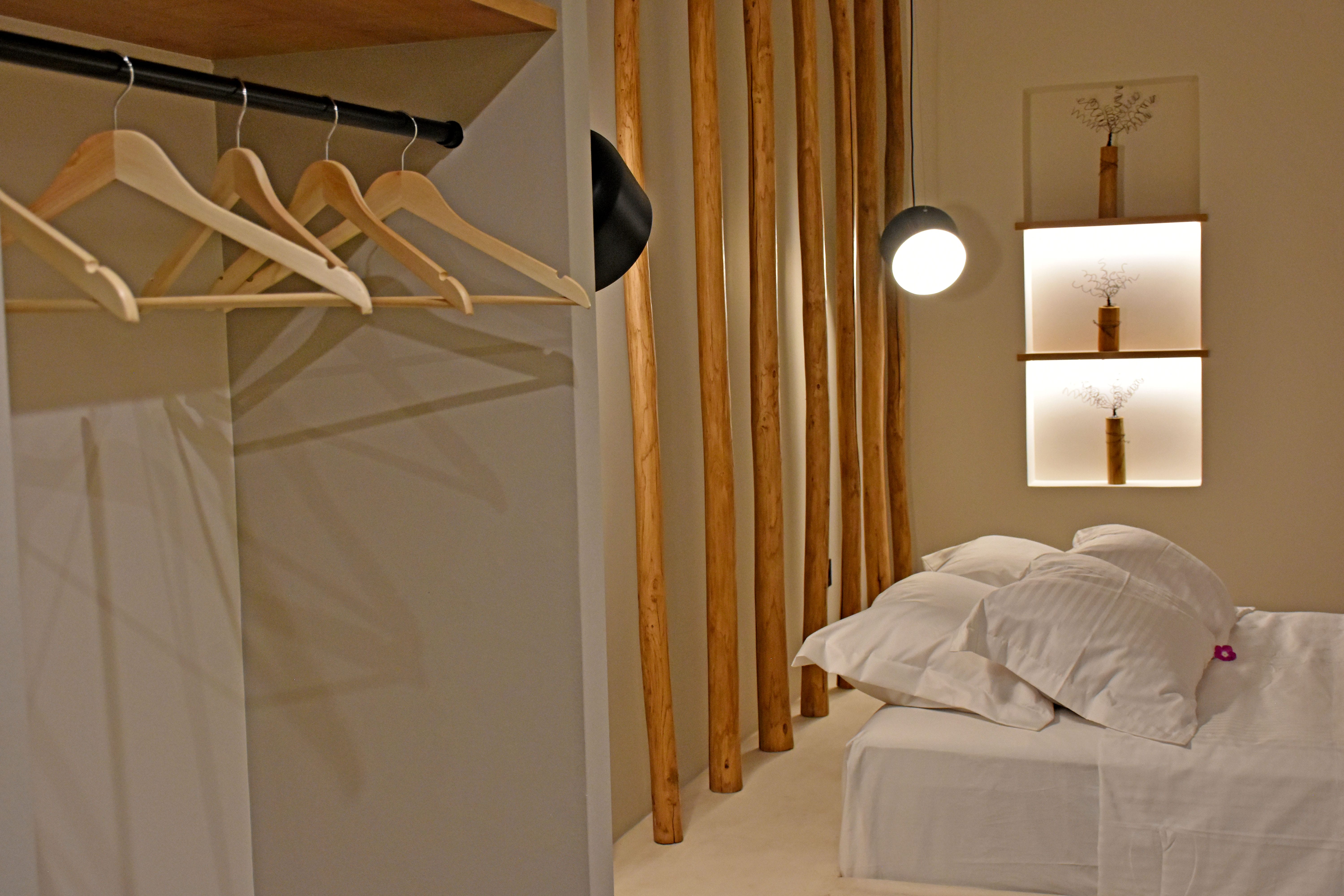 a bed with a mirror above it
