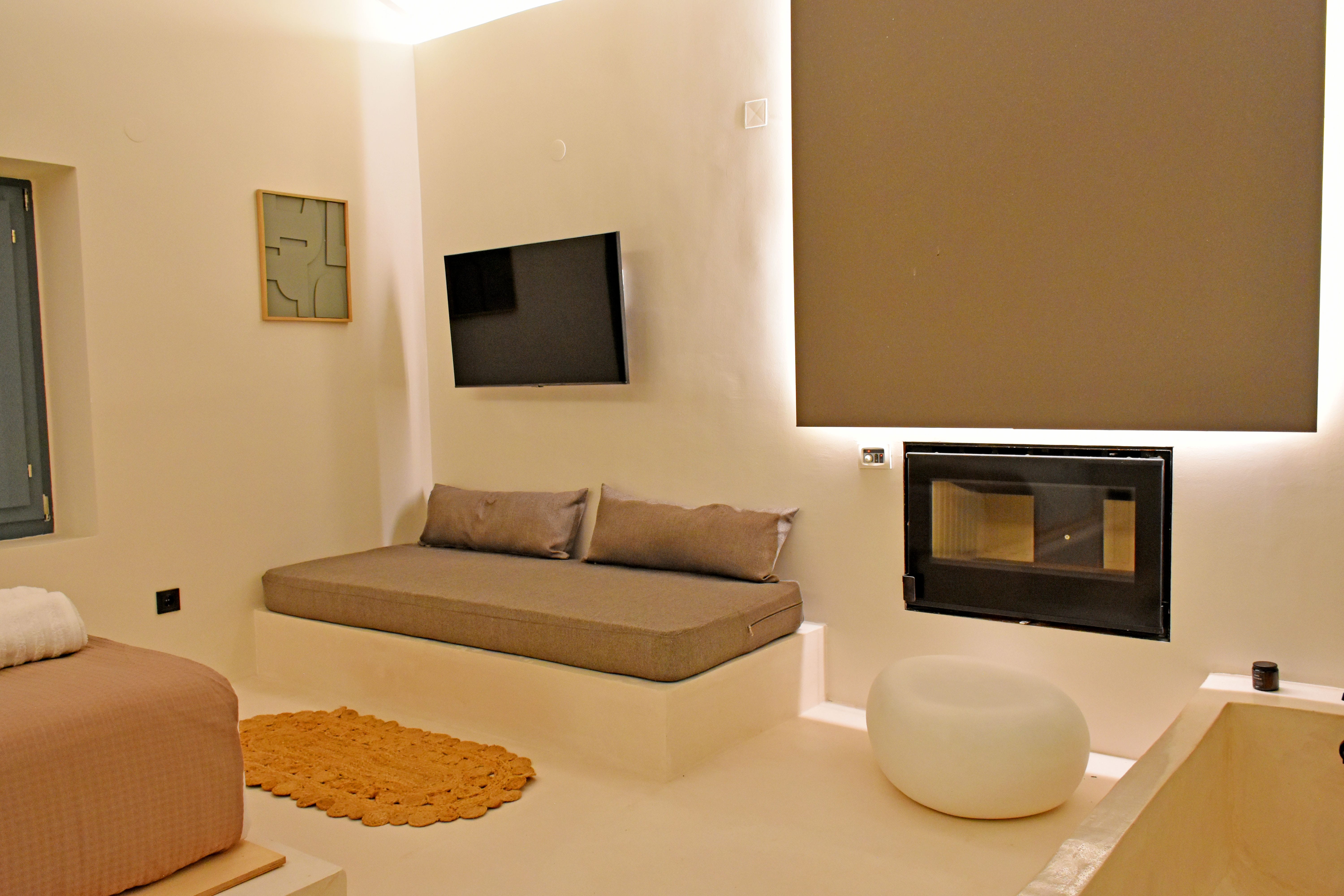 a living room with a tv and couches