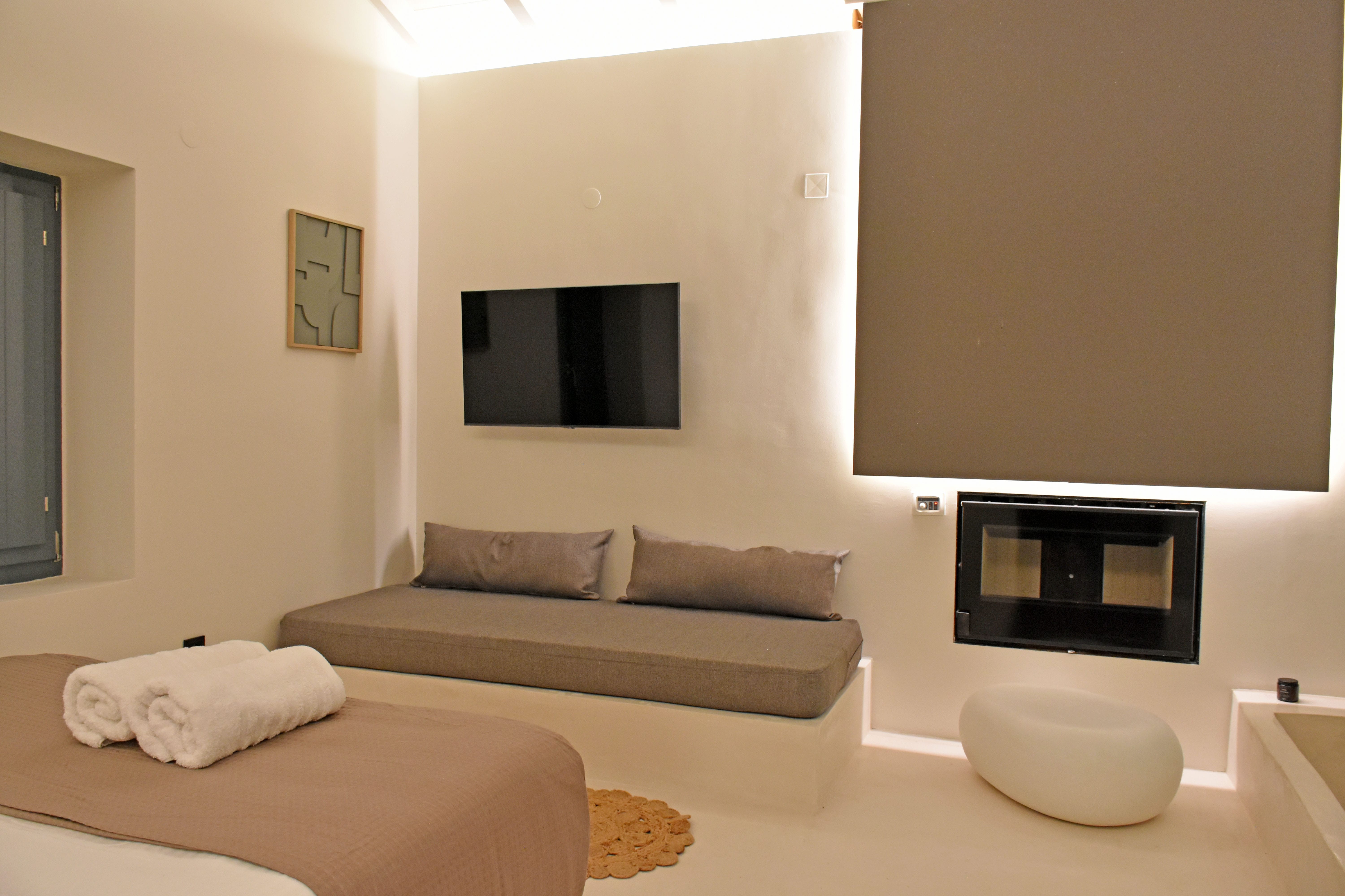 a room with a bed and a television