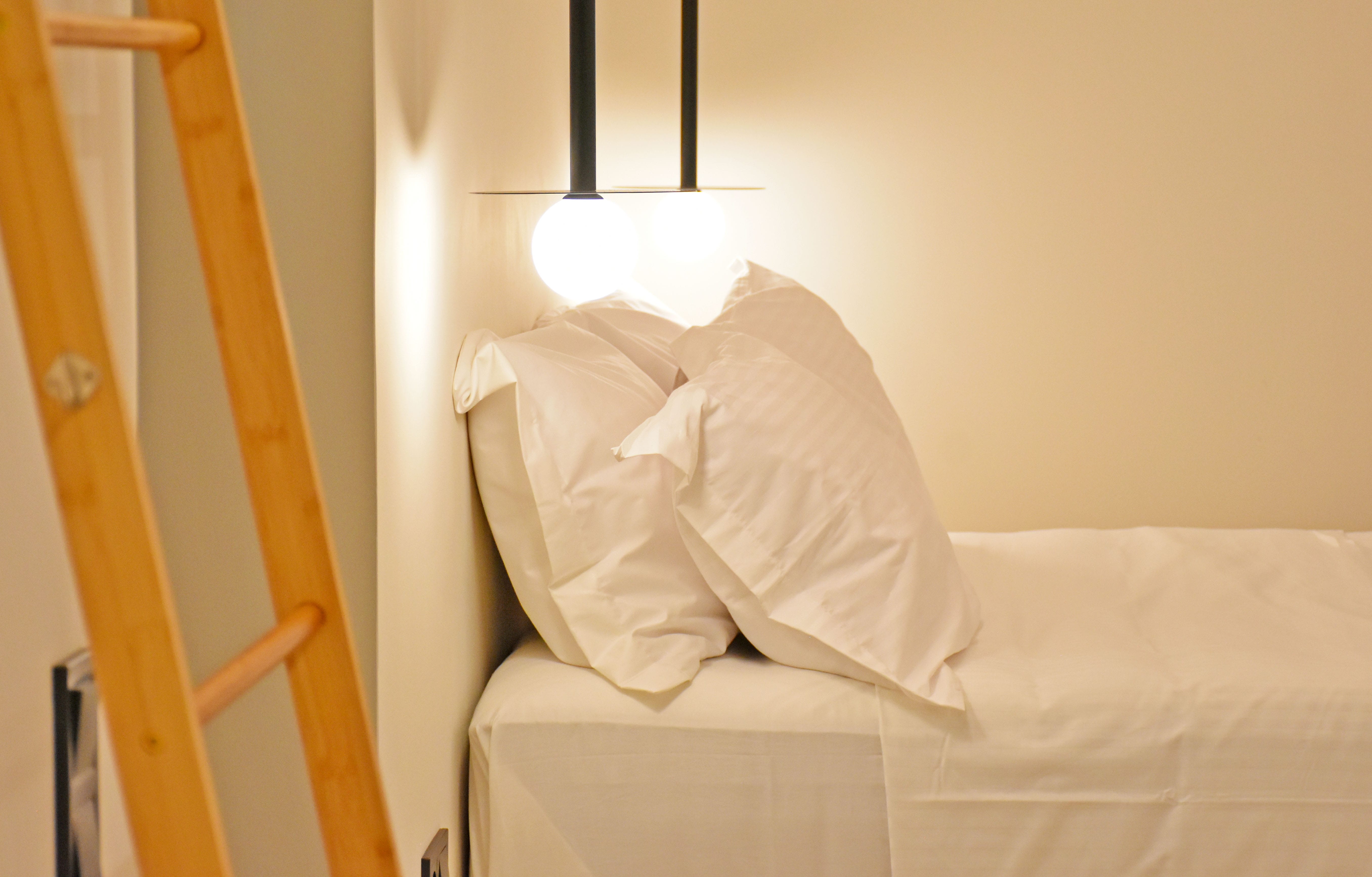 a bed with a white pillow