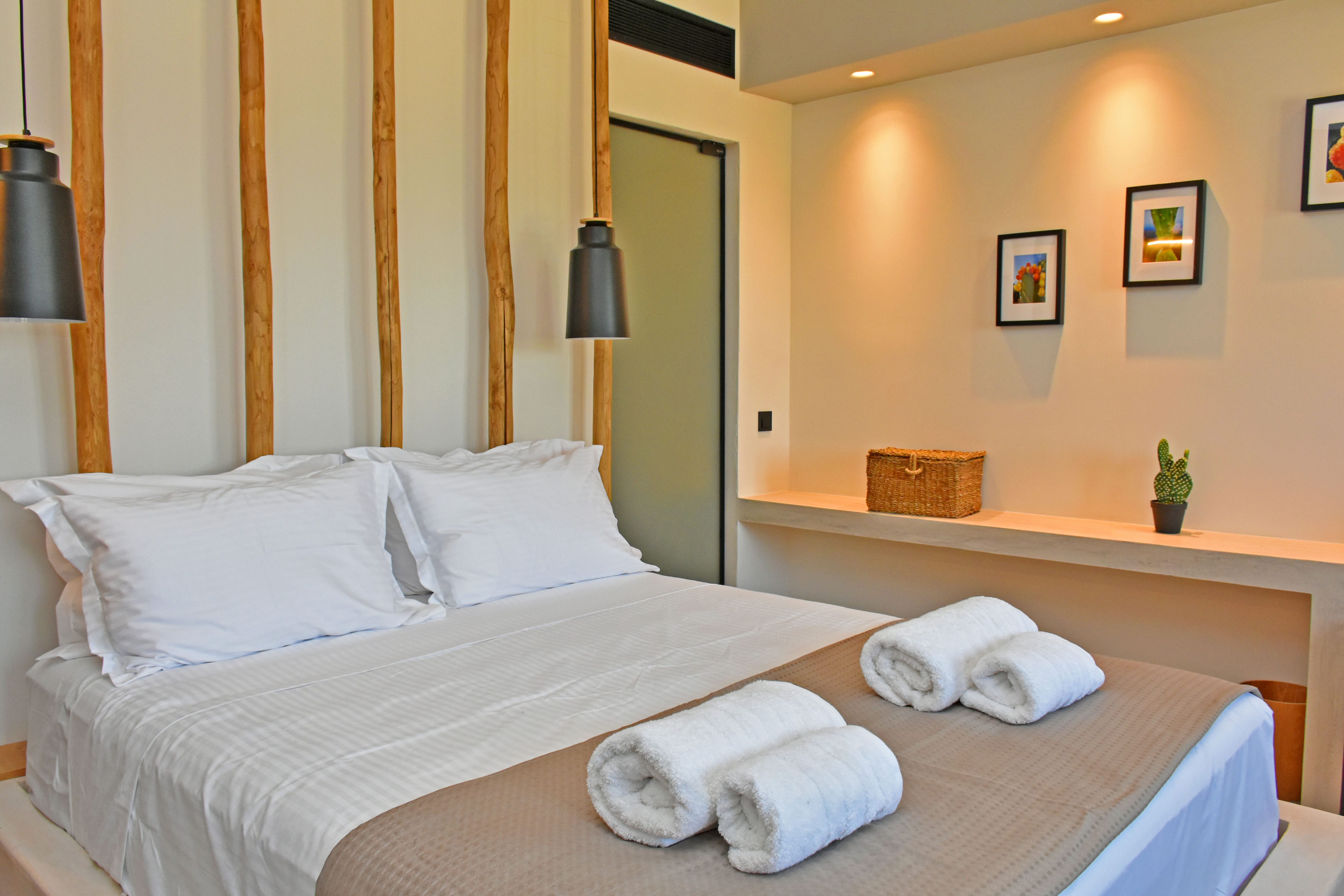 a hotel room with a bed and a lamp