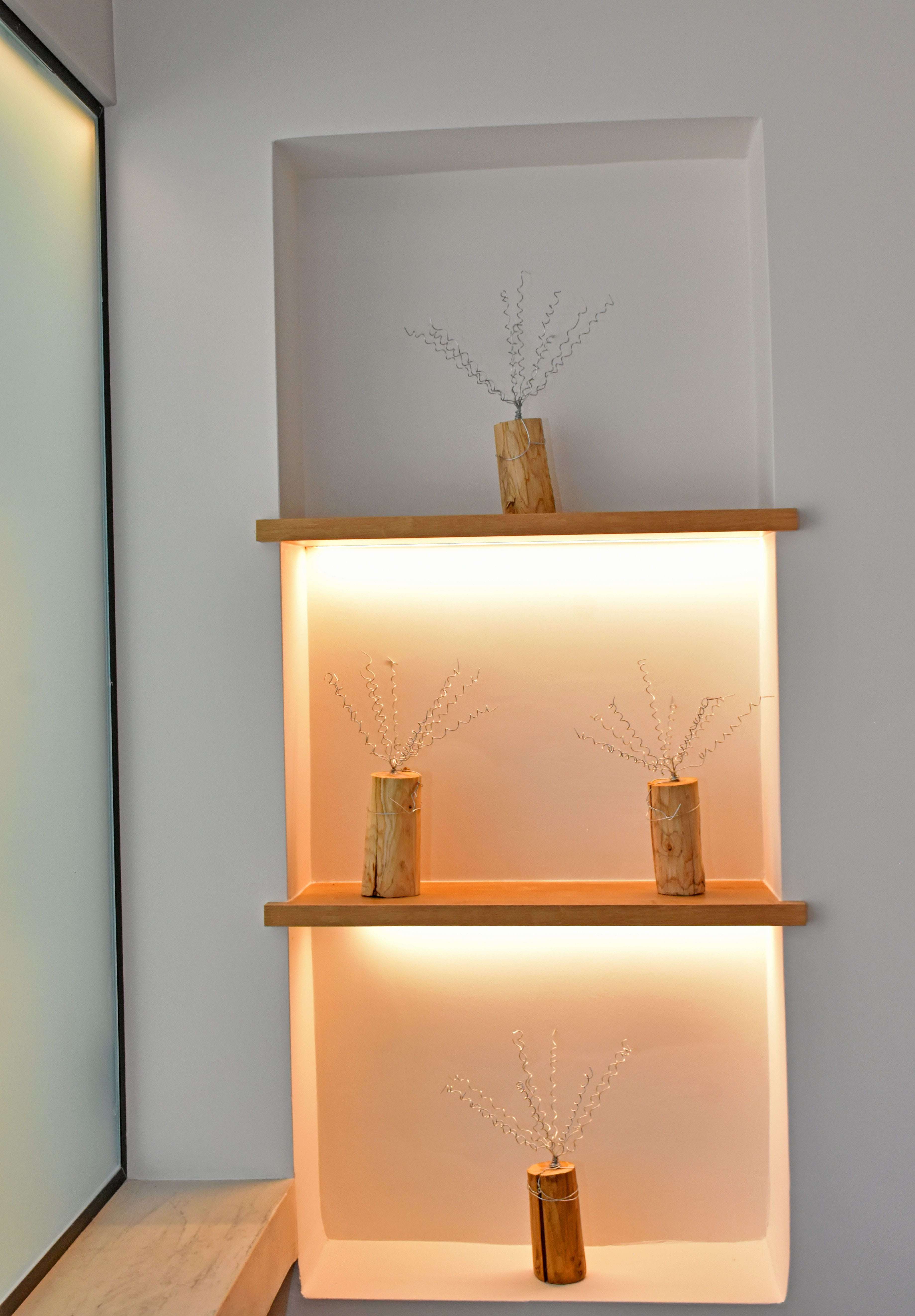 a shelf with vases and plants
