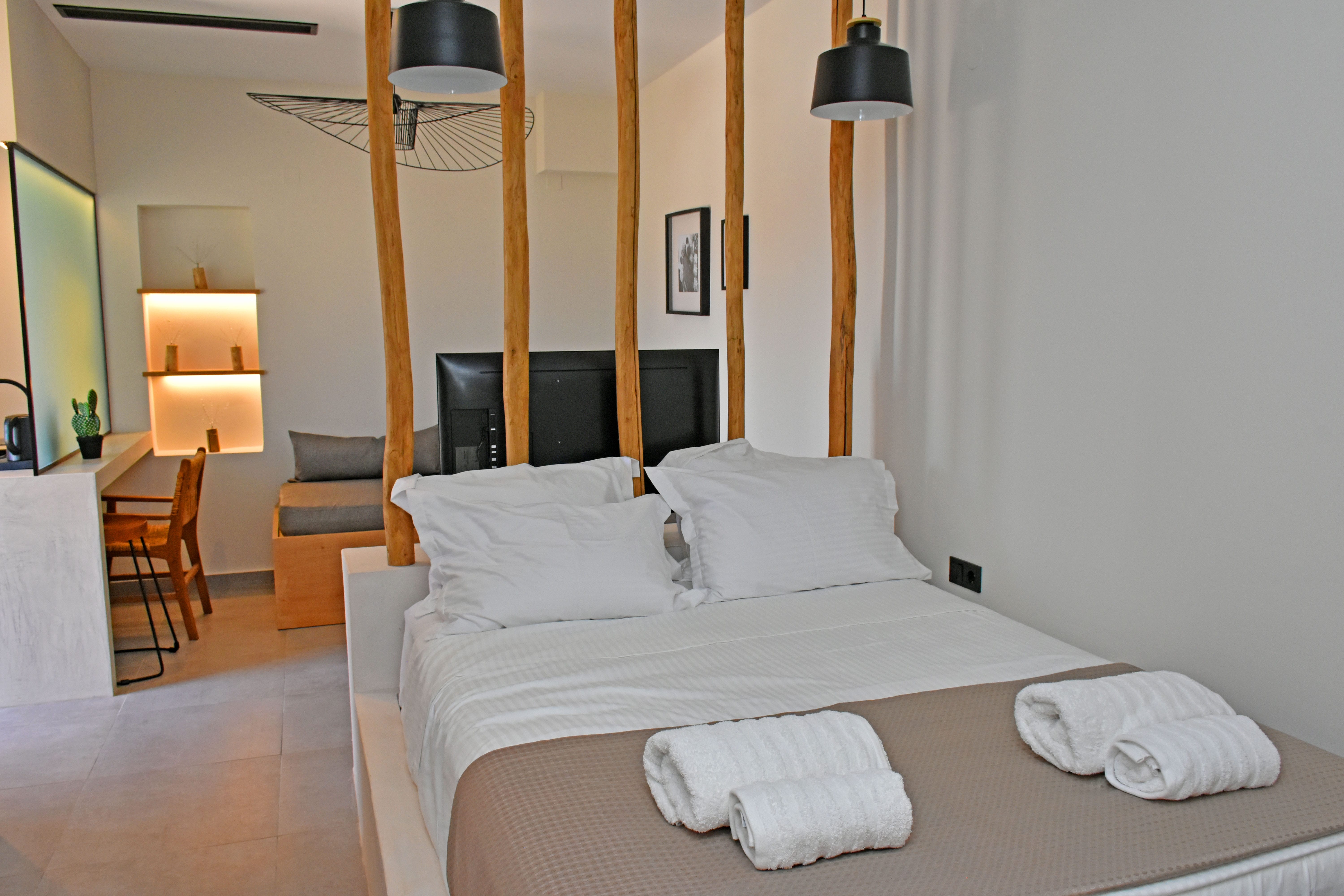 a hotel room with a bed and a lamp