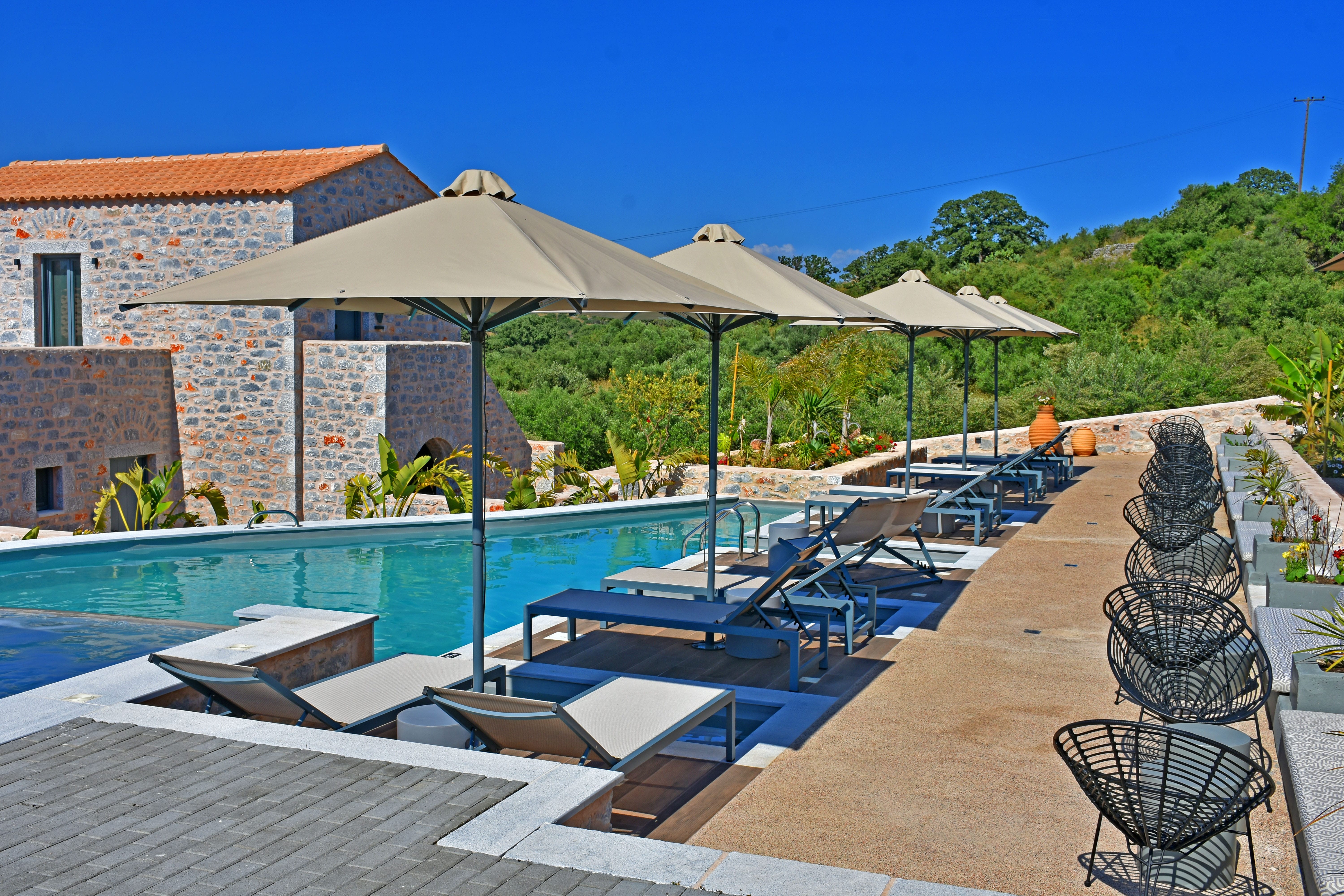 a pool with umbrellas and chairs next to it