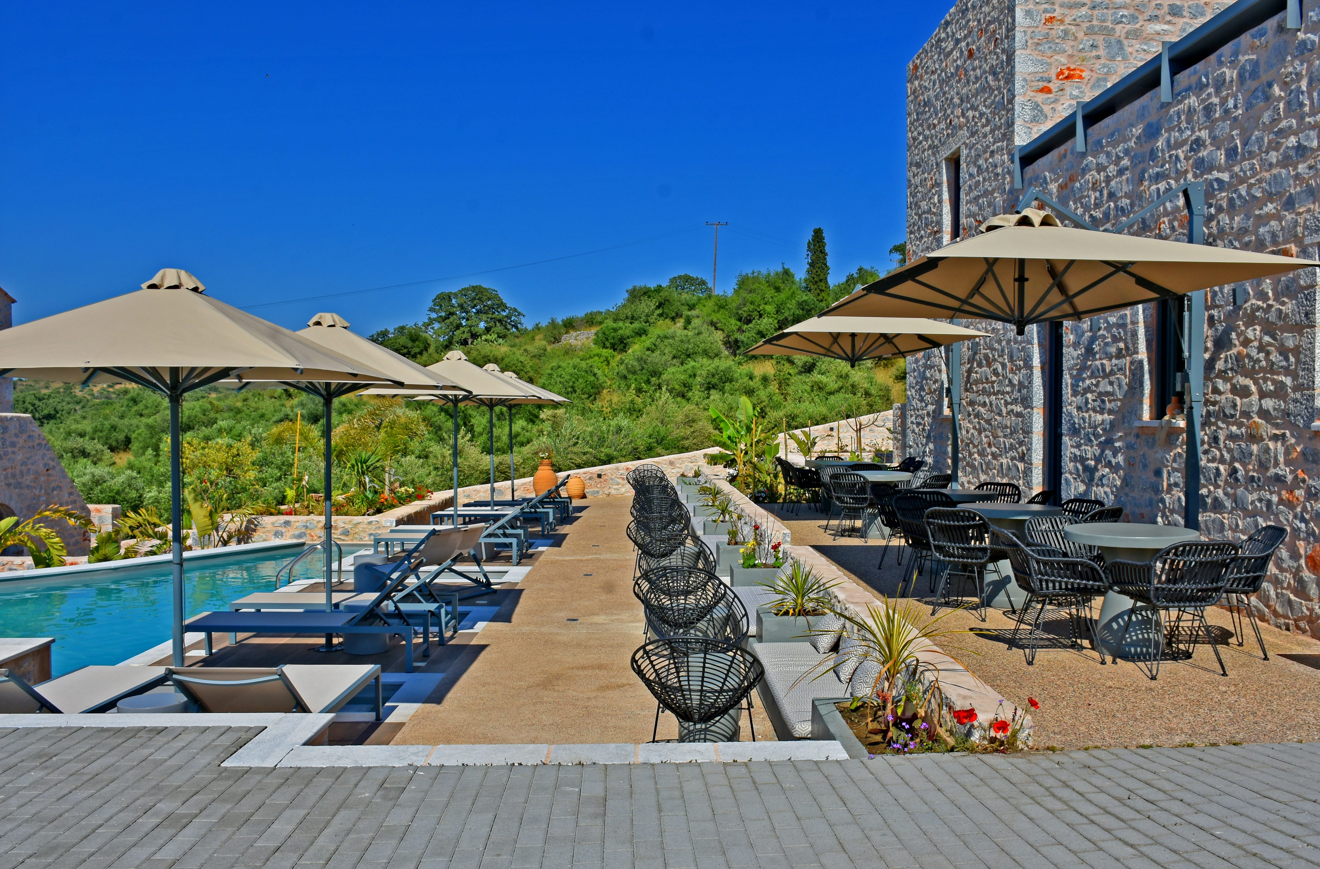 a pool and lounge chairs next to a building