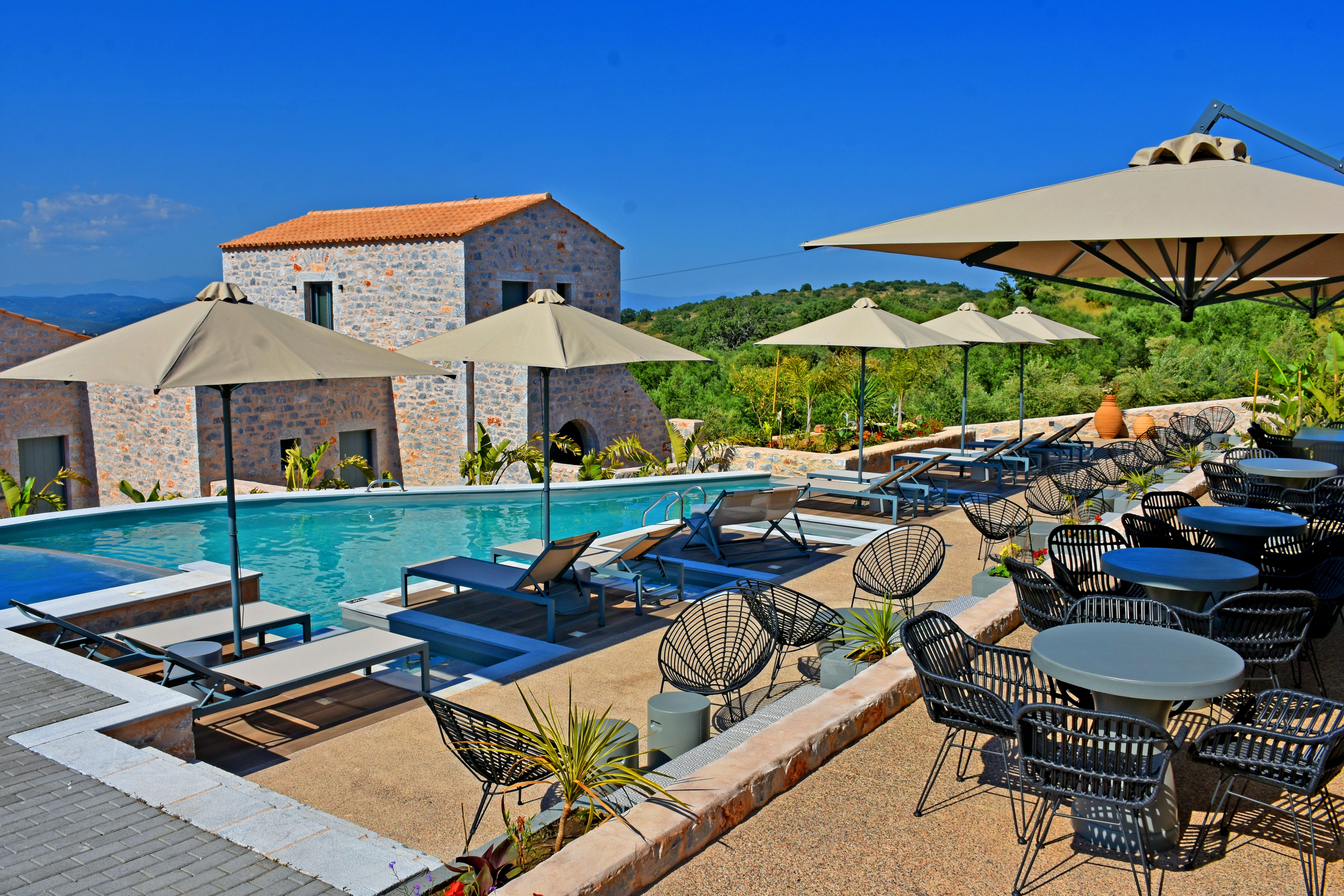 a pool with lounge chairs and umbrellas next to it