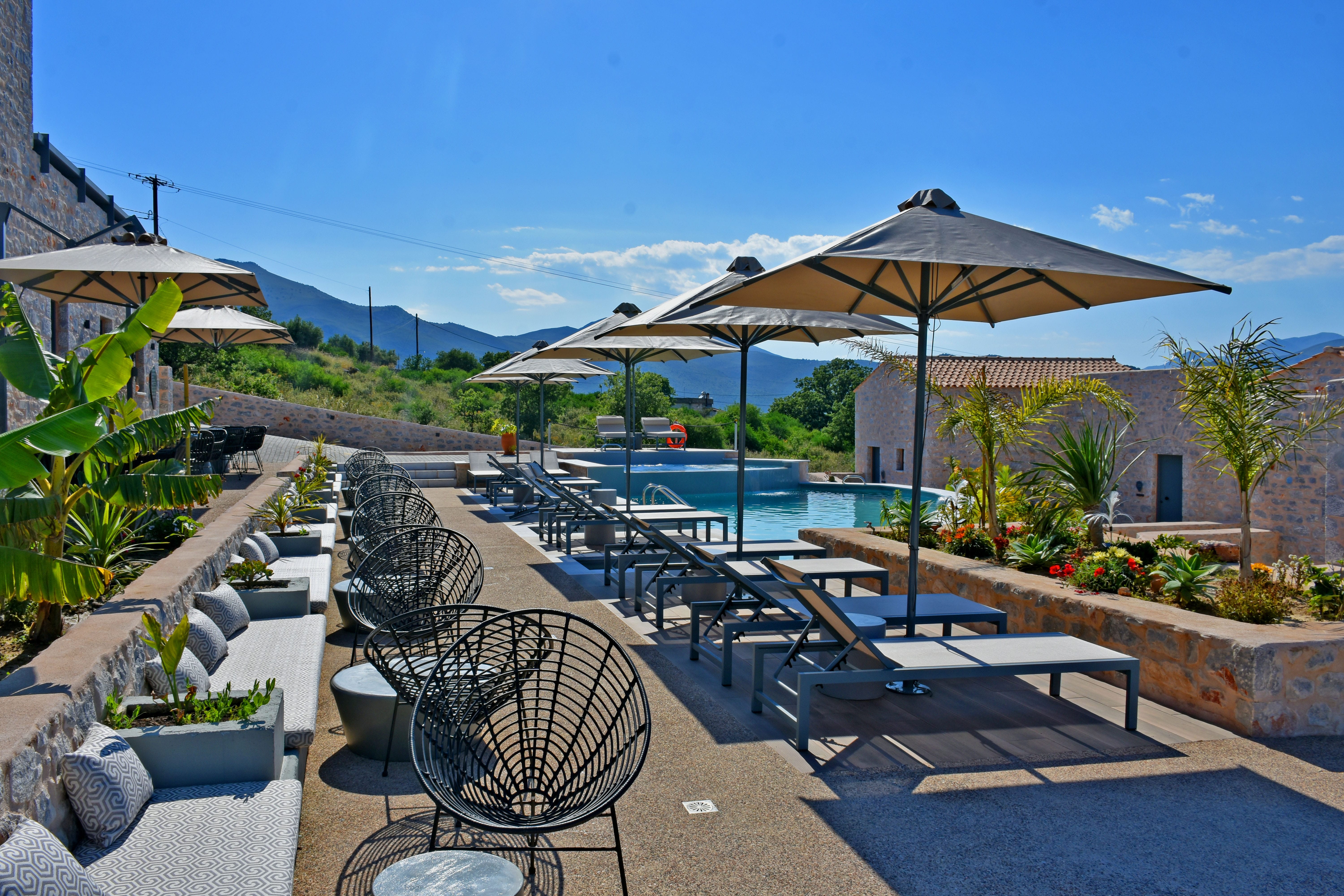 a patio with chairs and umbrellas