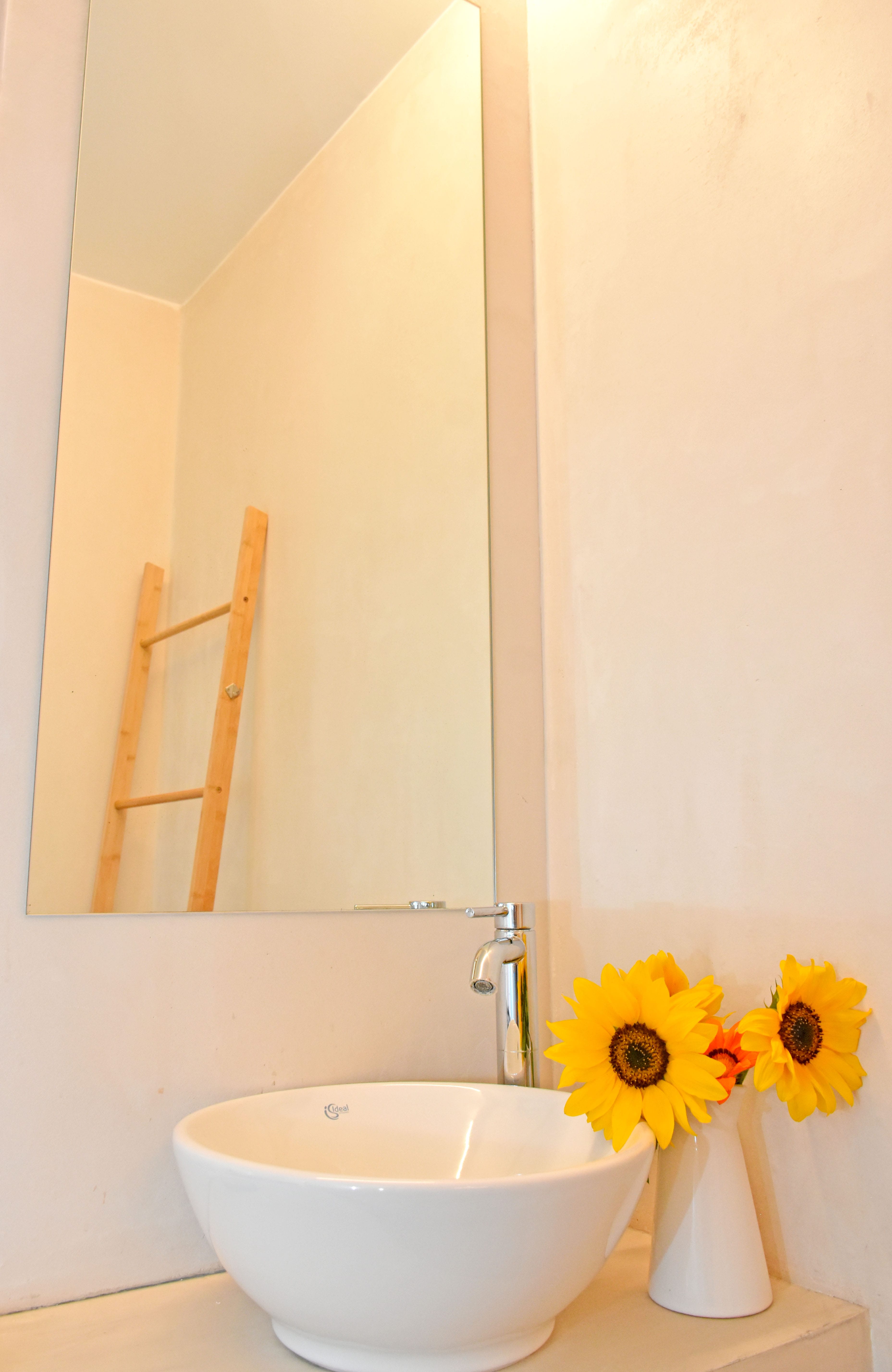 a sink with a vase of flowers