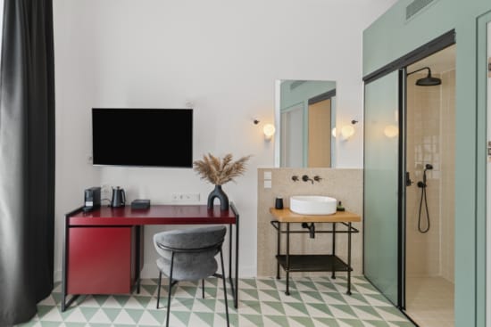 a bathroom with a red table and a tv